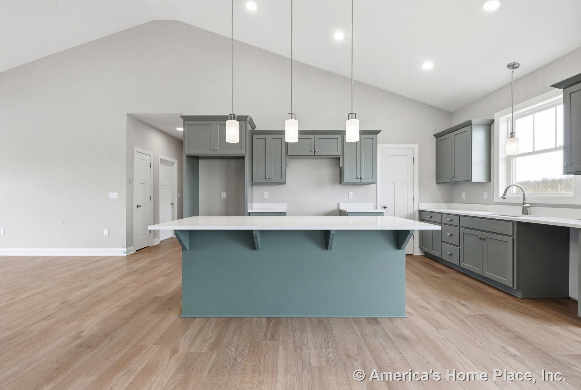 Kitchen with vaulted ceiling, light wood plank flooring, gray shaker cabinets, white quartz countertops, large central island, three pendant lights, recessed lighting, and a wide