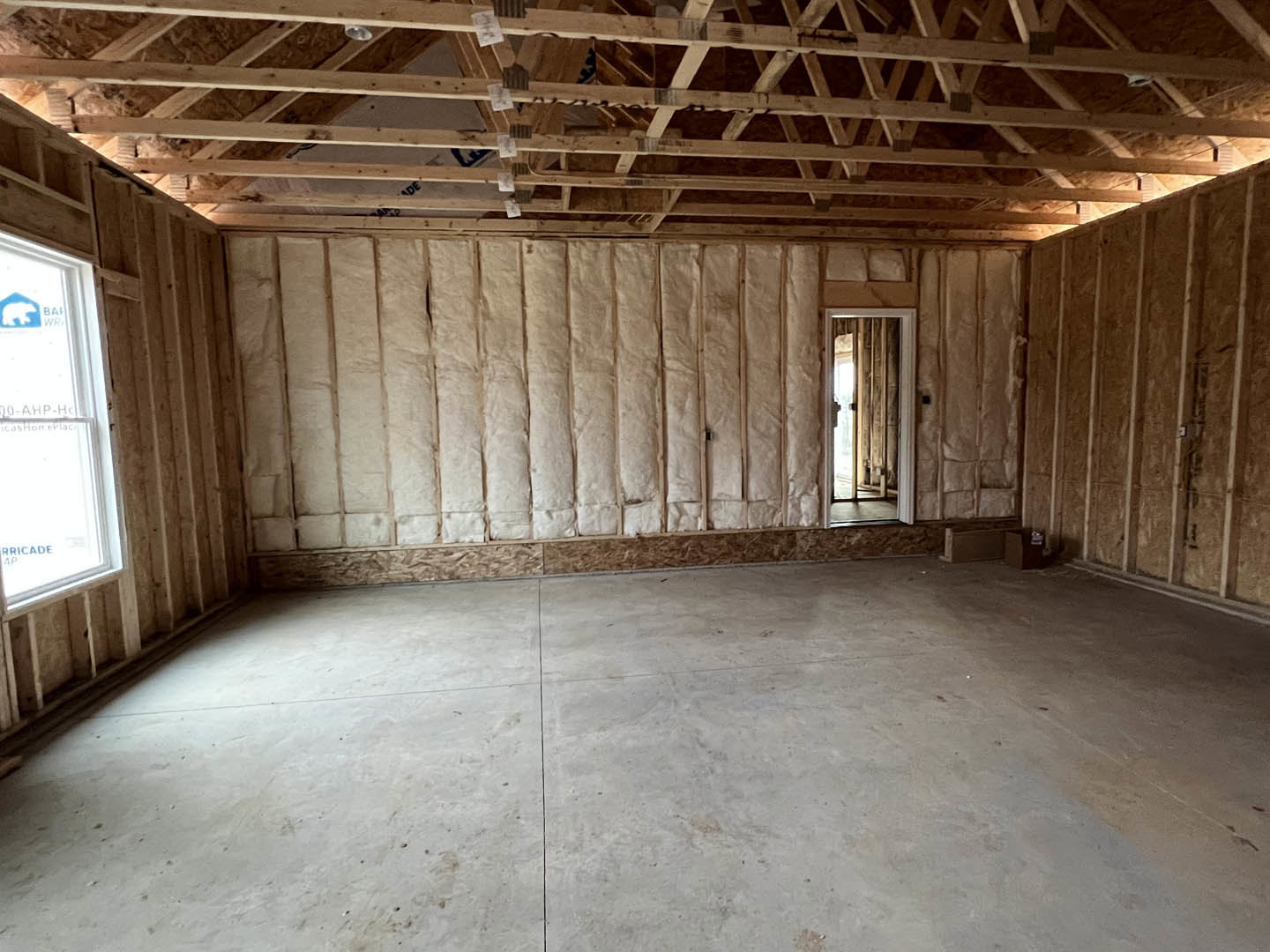 White tile floor, white-framed window, wooden ceiling beams, and a closed door set in a neutral wall within a modern interior room.
