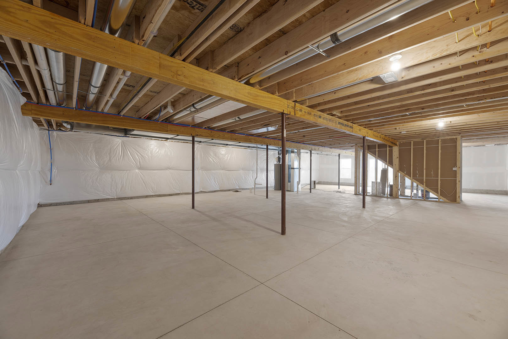Open room featuring exposed wooden ceiling beams, smooth white tile floor, and white walls.