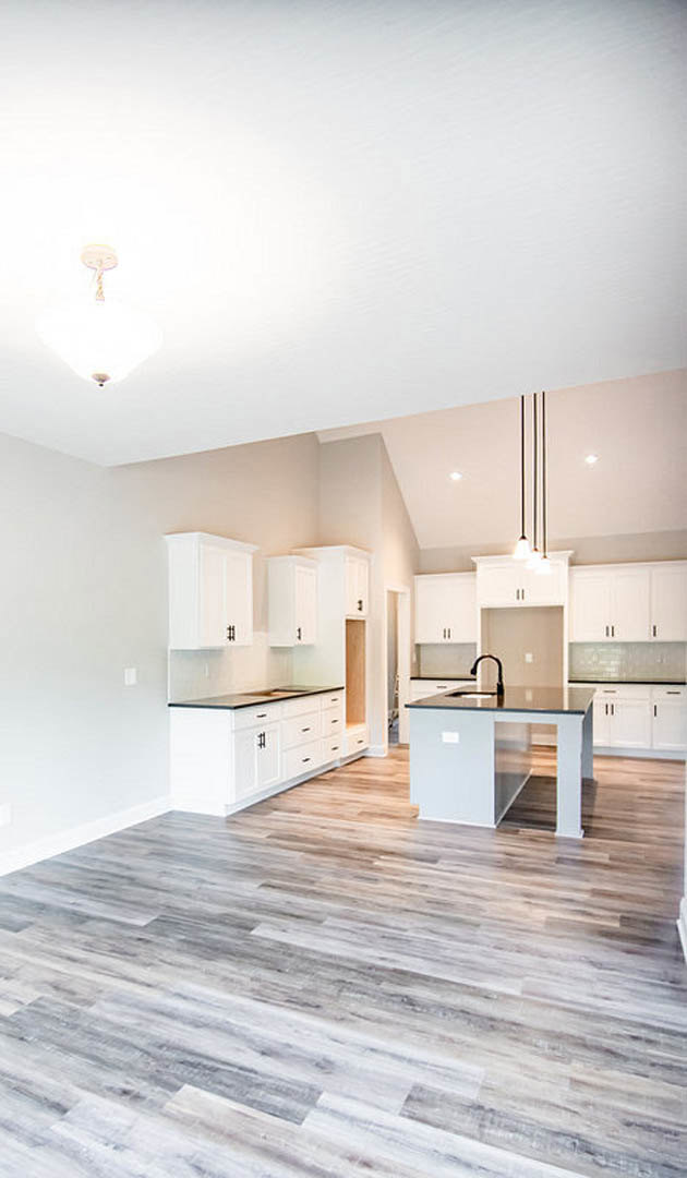 Kitchen with white cabinets, white countertops, central island, wood flooring, glass door, and modern ceiling light fixture