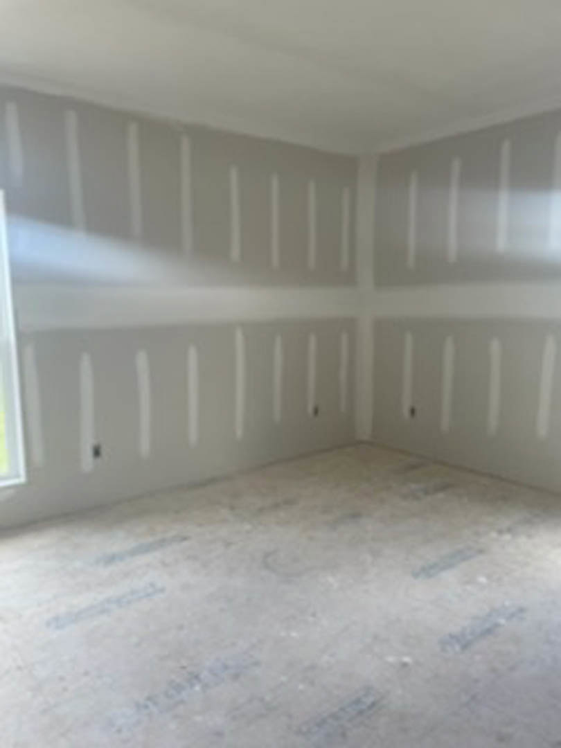 Bright room with smooth white painted walls, white flooring, simple molding, and recessed ceiling.