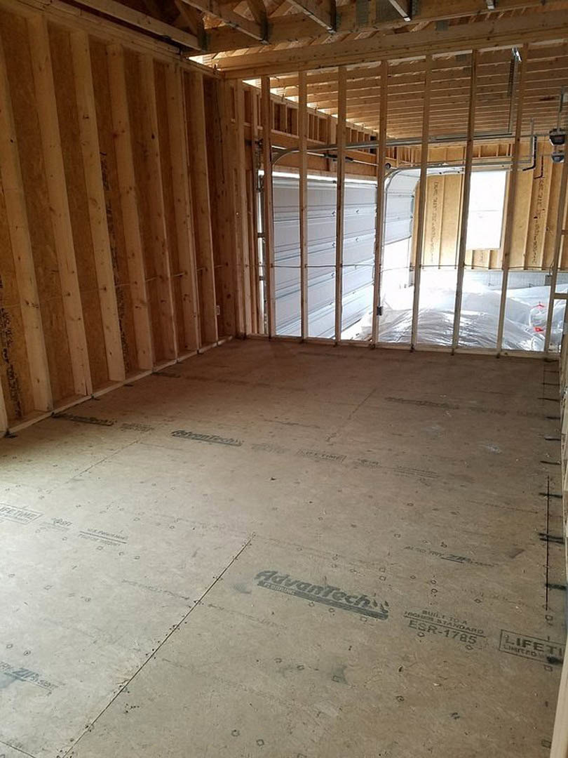 Living room with exposed wood ceiling beams, light-colored walls, and hardwood flooring