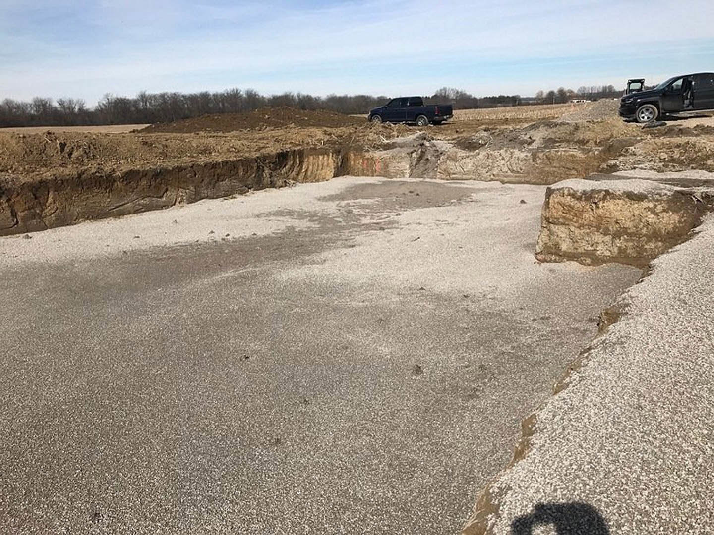 A truck parked in a dirt area.