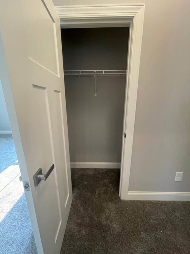 A closet with a door open.