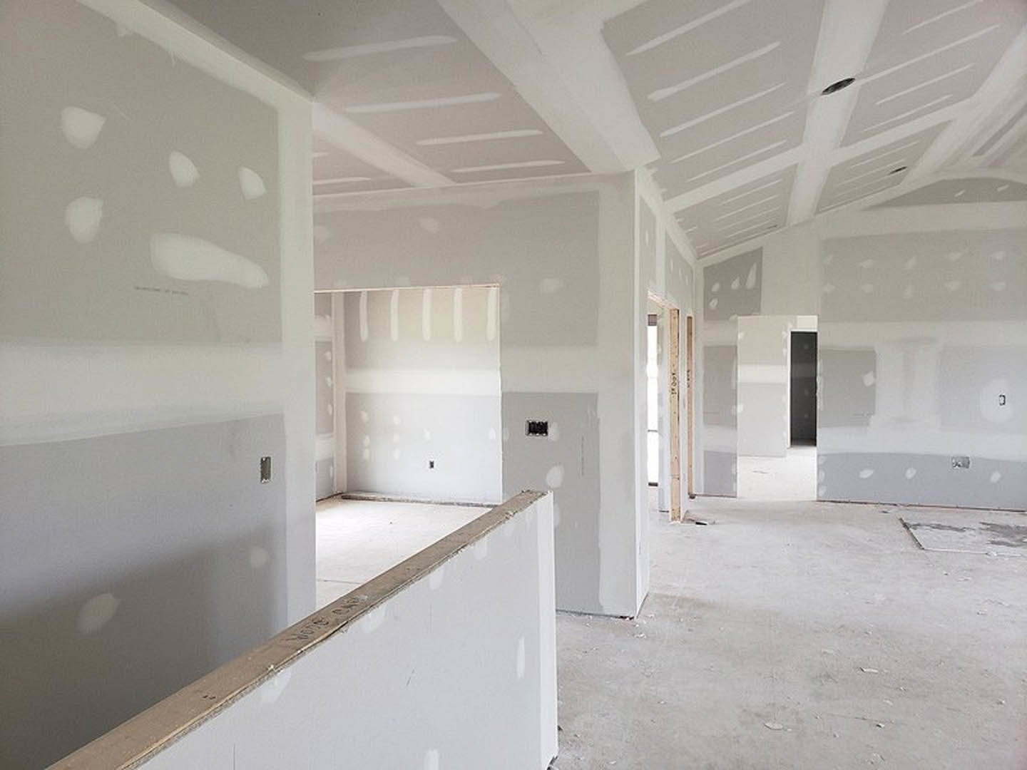 Room with smooth white plaster walls, white painted ceiling, and polished concrete floor