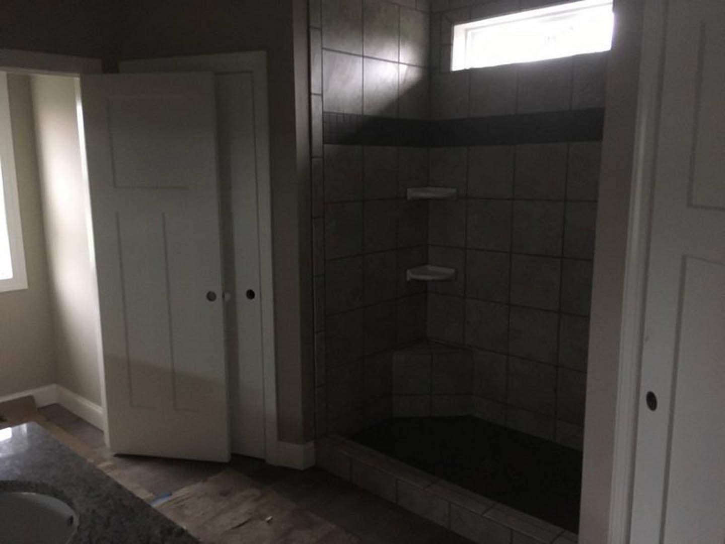 Bathroom with tiled shower, glass door, and vessel sink on vanity