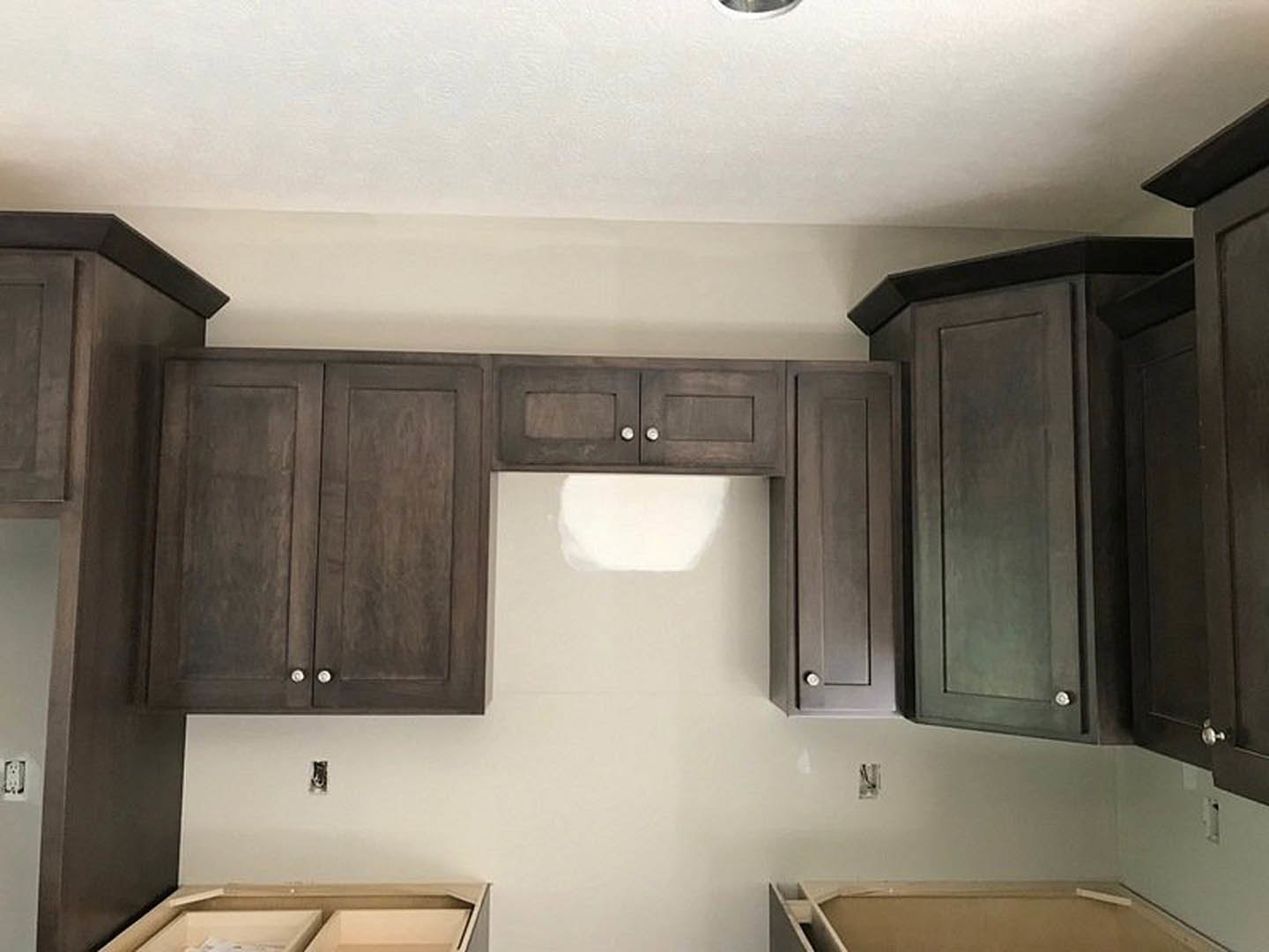Kitchen with dark wood cabinets, white quartz countertops, stainless steel appliances, and a chrome faucet over an undermount sink