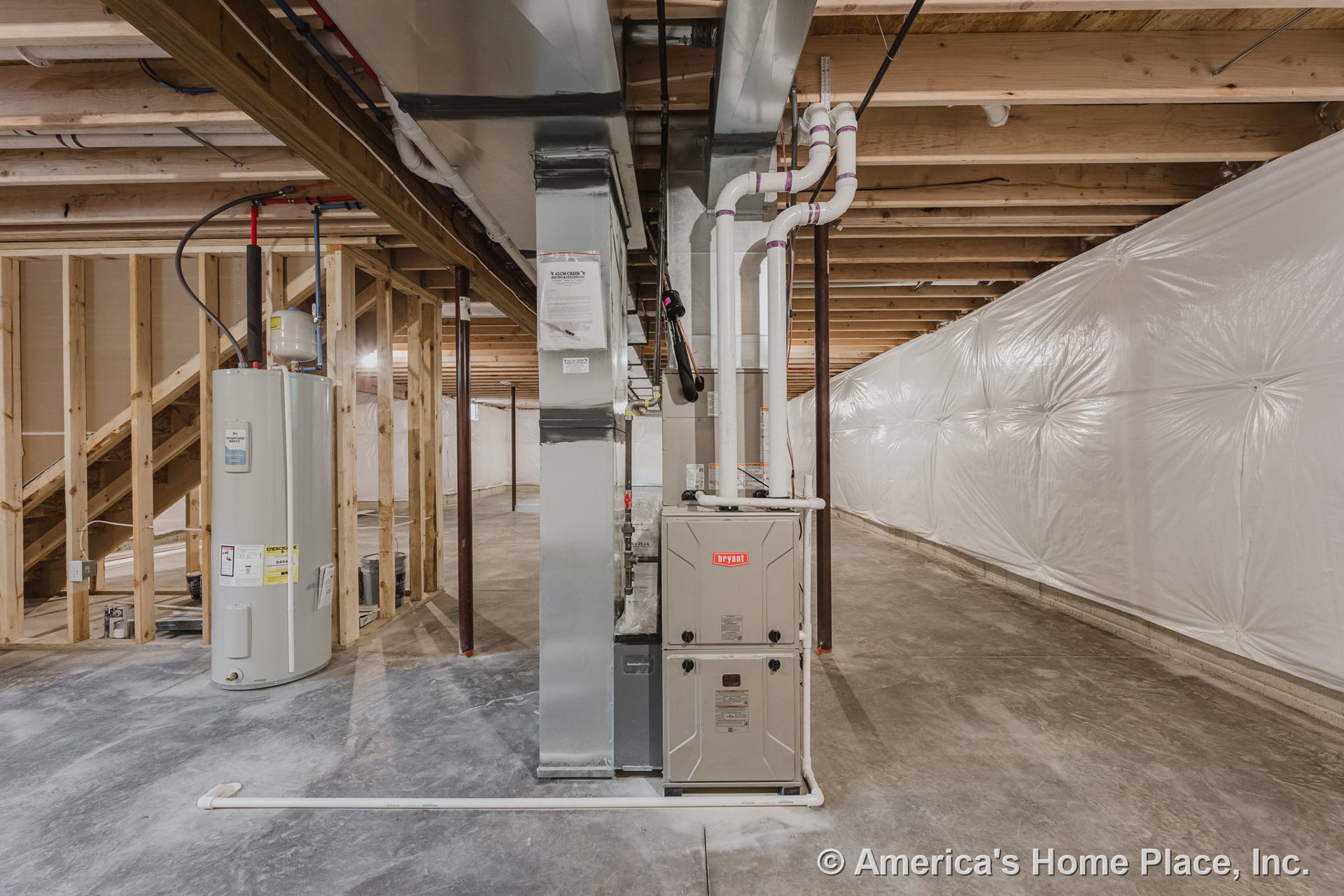 Unfinished basement with exposed wood ceiling joists, concrete slab floor, framed staircase, plastic vapor barrier wall, central HVAC unit, water heater installation, and open