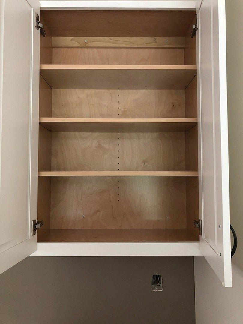 Wooden shelf inside a cabinet with smooth finish, empty and surrounded by wood grain panels