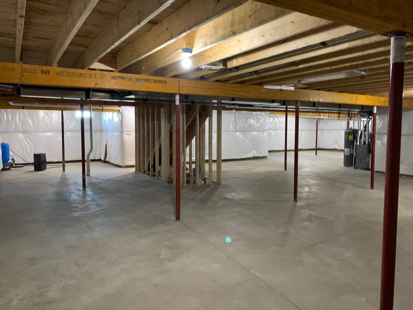 Living room with exposed wooden ceiling beams, wood plank ceiling, light-colored walls, and hardwood flooring
