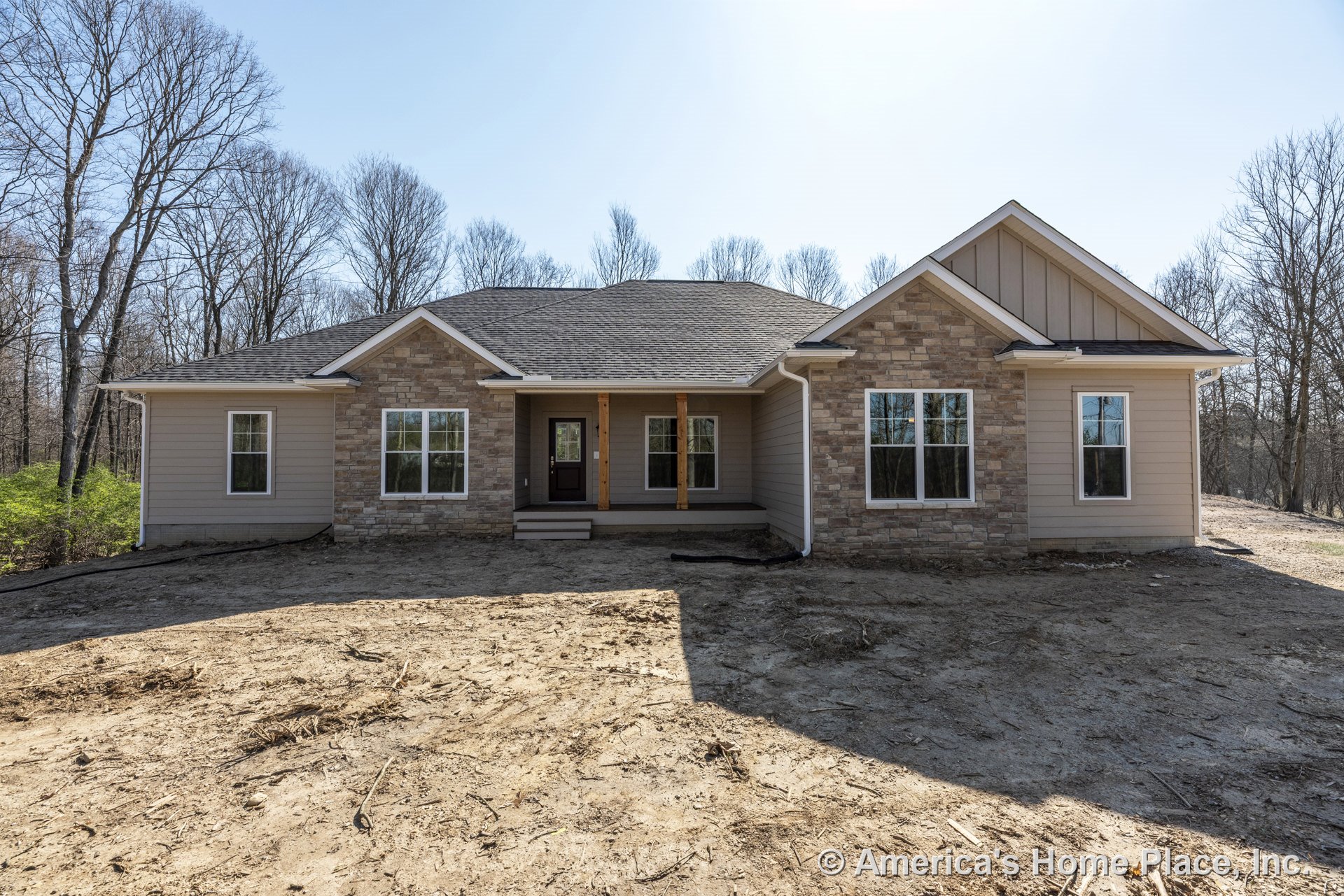 Stone veneer and horizontal siding exterior with gable roof, covered front porch supported by double columns, multiple large windows, front door, decorative trim, and entry steps.