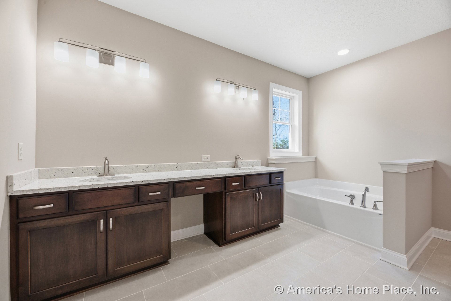 Double vanity with dark wood cabinets and solid surface countertops, large built-in bathtub, tile flooring, wall-mounted vanity lighting, chrome fixtures, recessed ceiling light