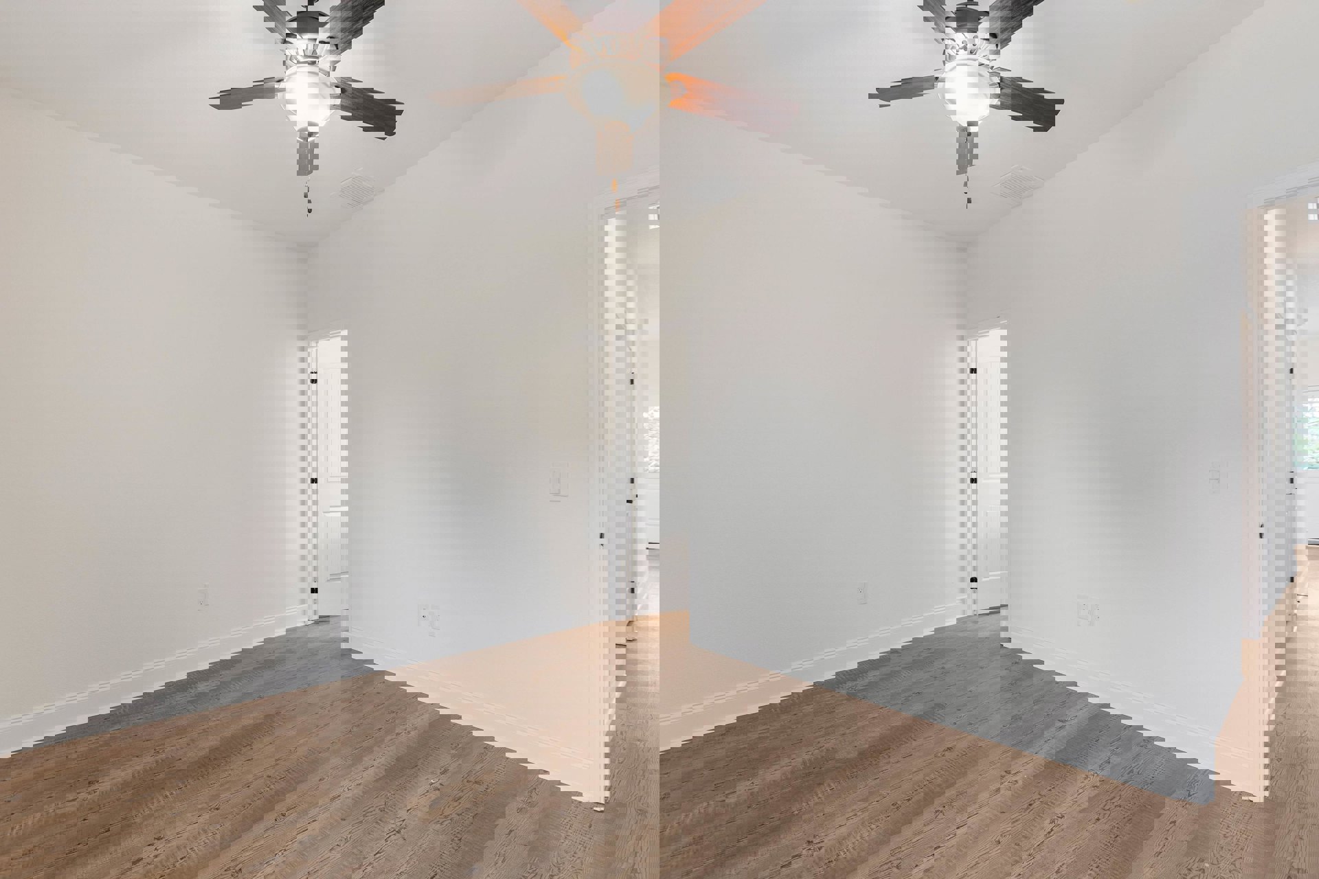 Ceiling fan with integrated light fixture mounted on white plaster ceiling, wood flooring, white walls, and white door with black hinge in residential room