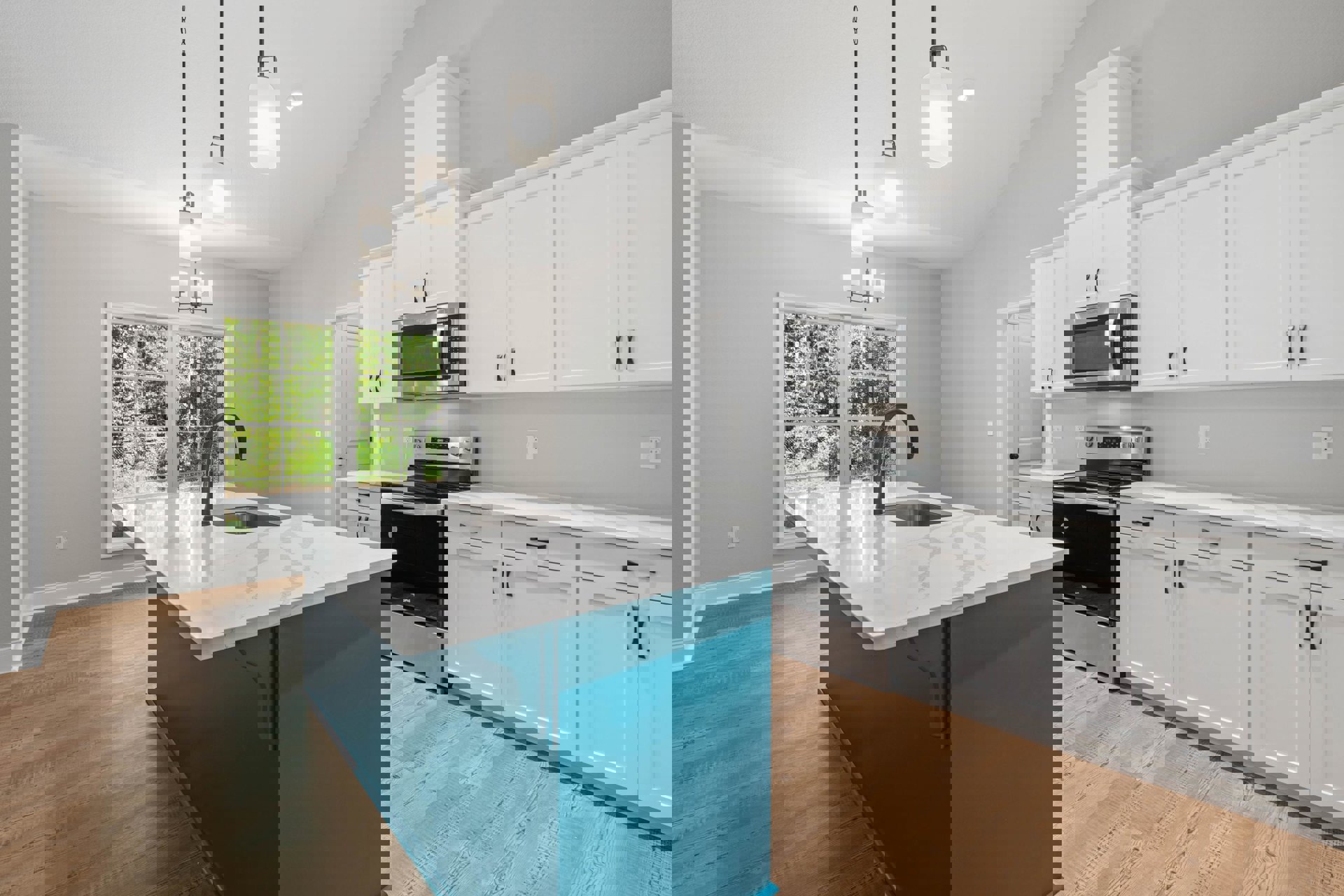 Blue kitchen island with built-in sink, white shaker cabinets, stainless steel microwave and oven, light fixture near window, hardwood flooring