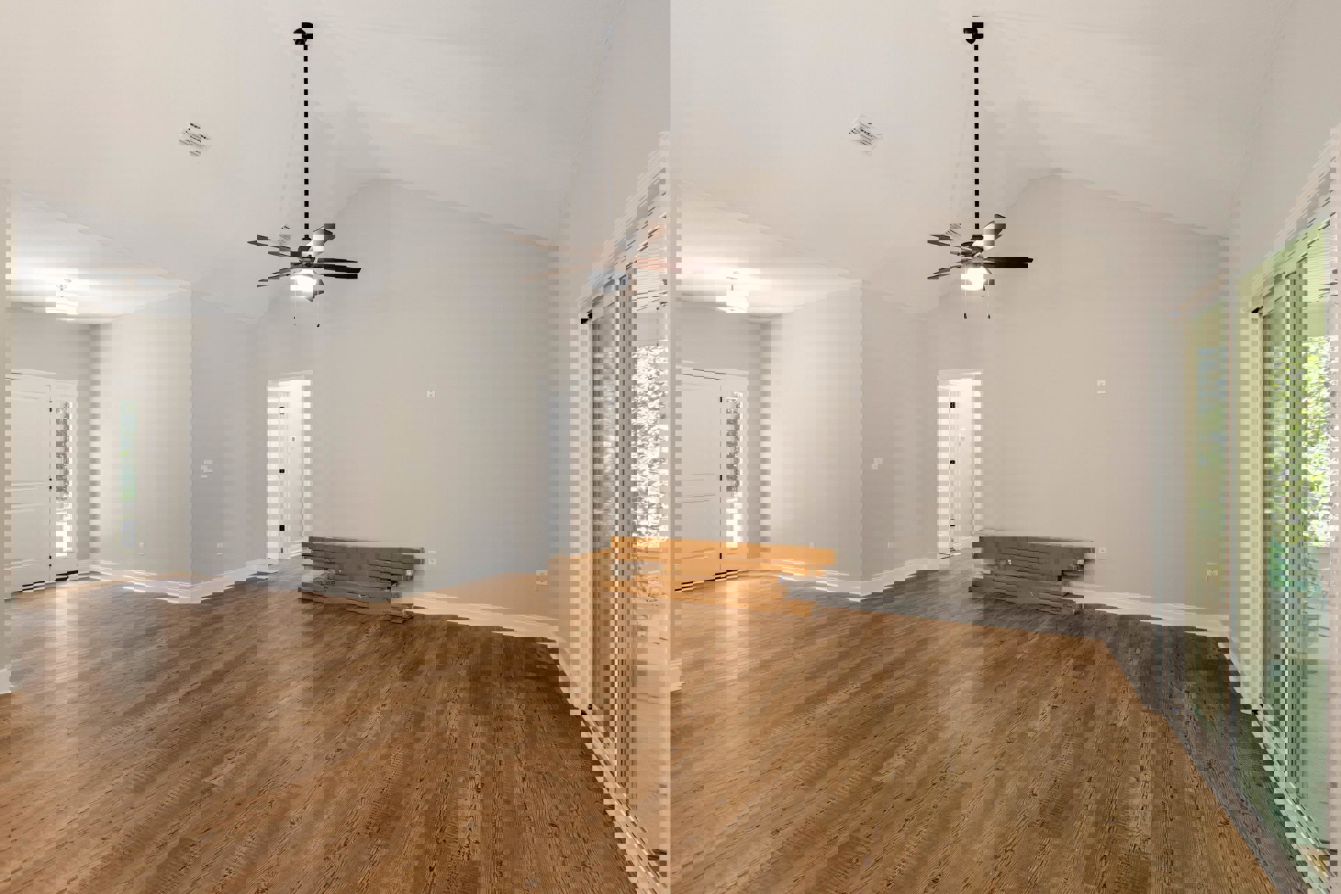 Ceiling fan with light fixture on white ceiling, hardwood floors, white door with glass panel, stack of brown moving boxes against plaster wall
