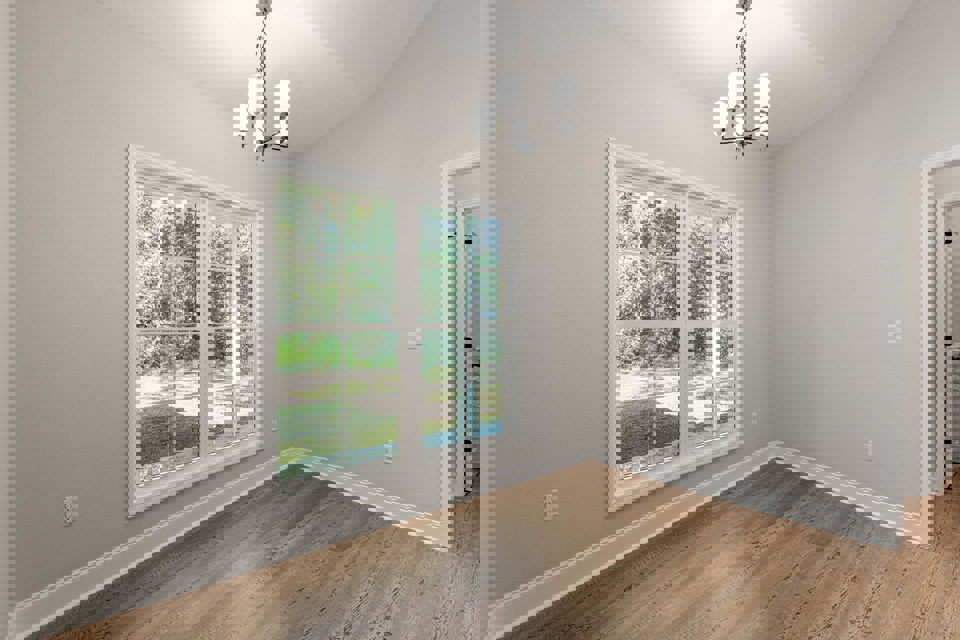 Sunlit room featuring wide plank wood laminate flooring, plaster walls, large window with outdoor view, and modern chandelier with white lamps.