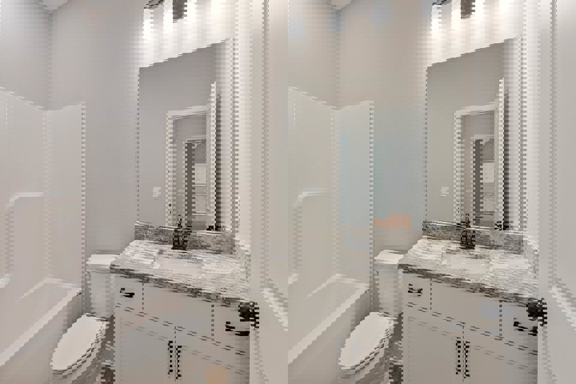 Bathroom with white toilet, marble countertop, rectangular sink, and white bathtub against light-colored tile walls.