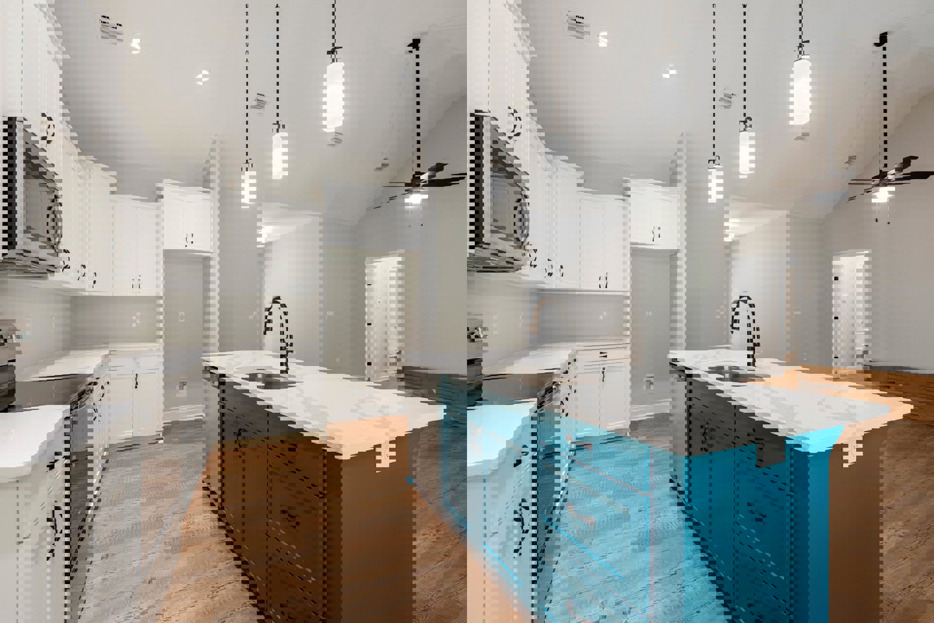 Blue kitchen island with black faucet, white shaker cabinets, quartz countertops, stainless steel appliances, light fixture above island, white door with black hinges, hardwood