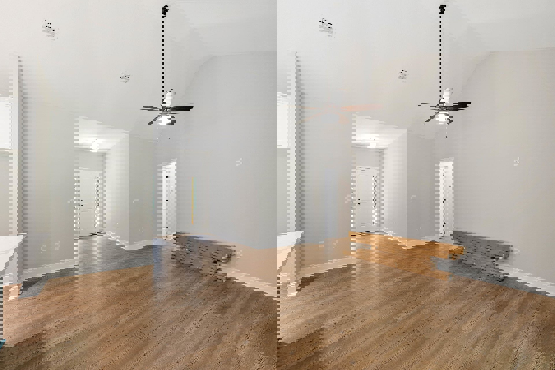 Hardwood flooring, white walls, ceiling fan with light fixture, stack of cardboard boxes near white door with glass panel