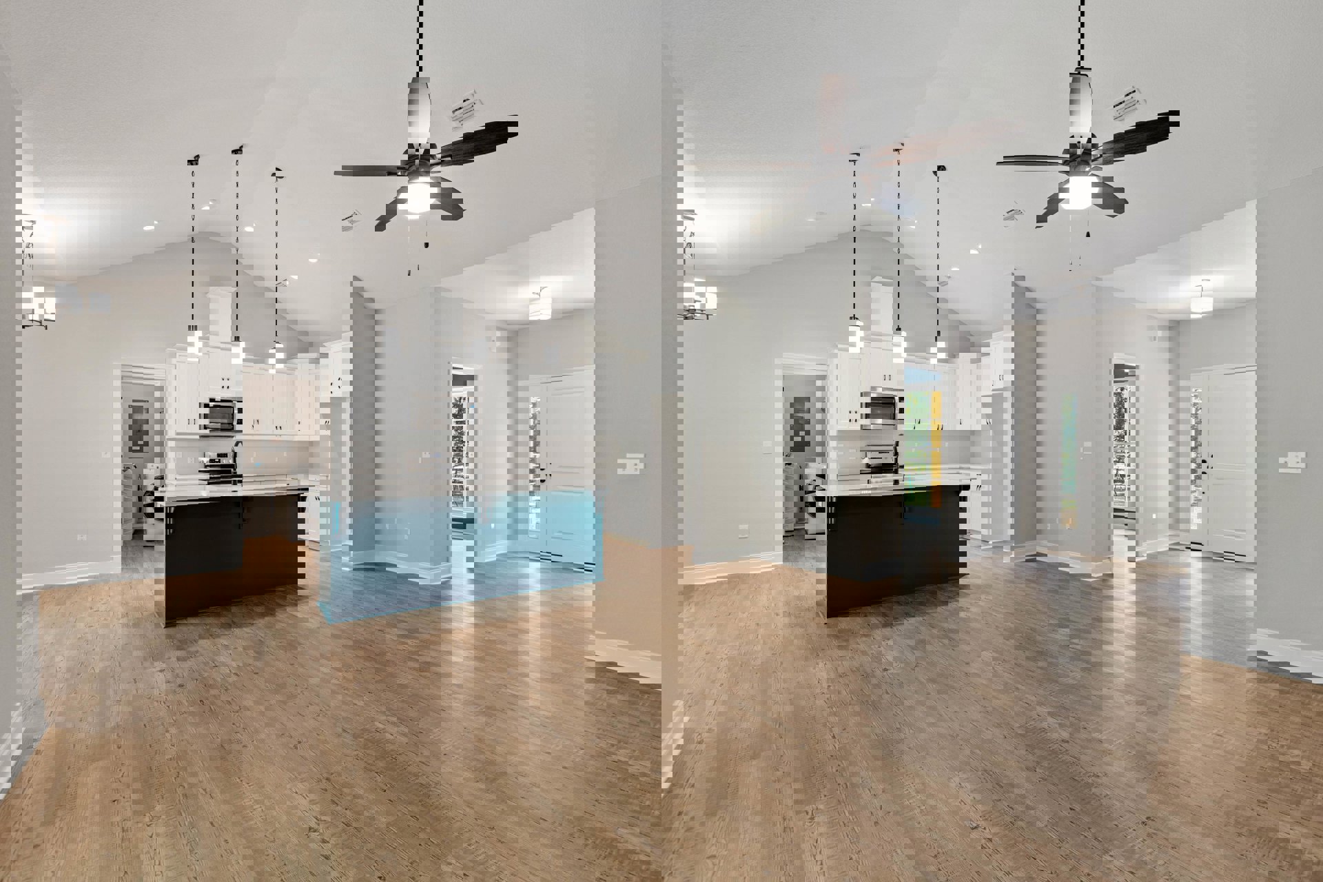 Spacious open floor plan featuring a kitchen island with a black faucet, white cabinetry, built-in microwave, laminate wood flooring, ceiling fan with light, and white door with