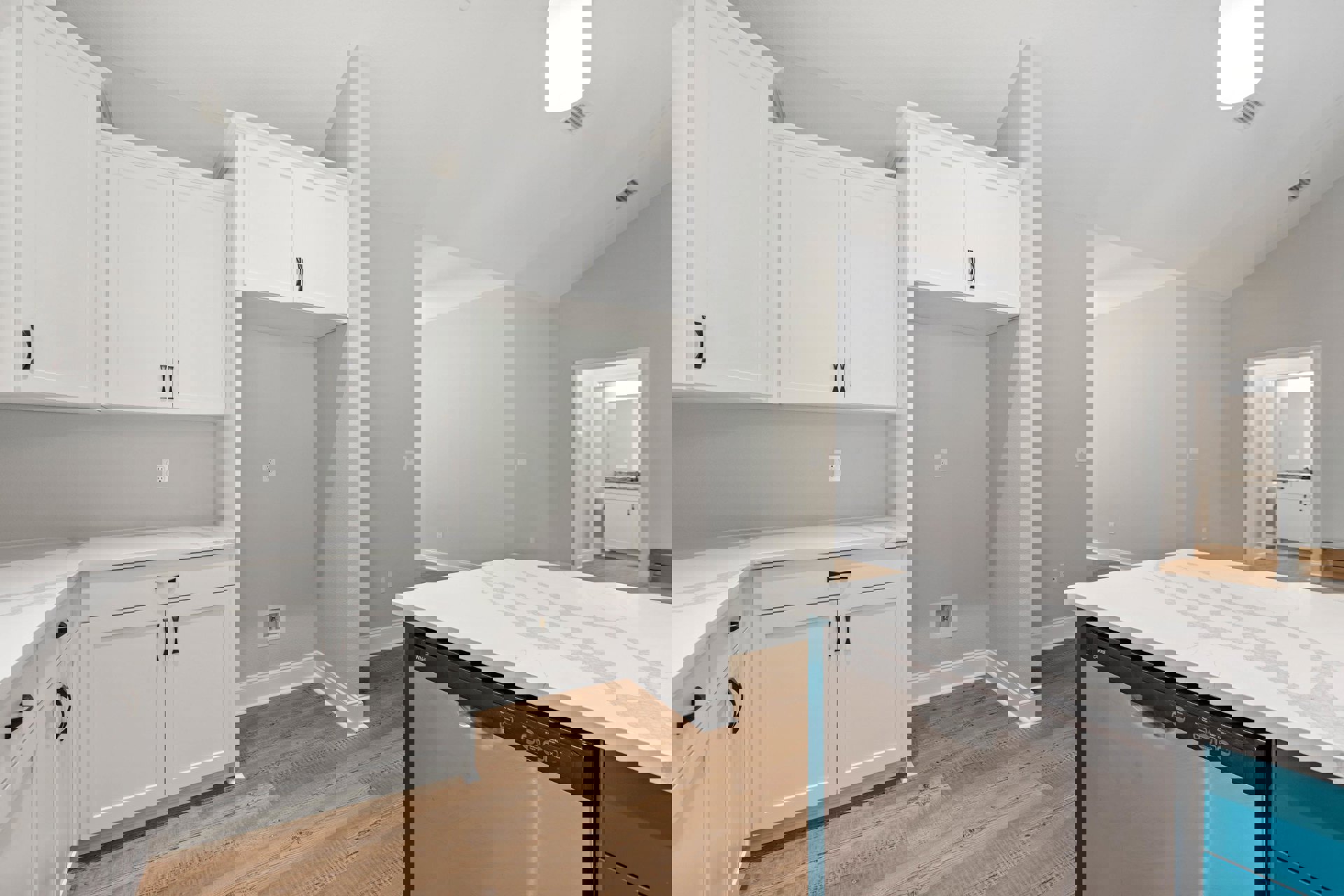 Kitchen with white shaker cabinets, black handles, wood plank flooring, white quartz countertops, stainless steel dishwasher, and a white door with a black handle.