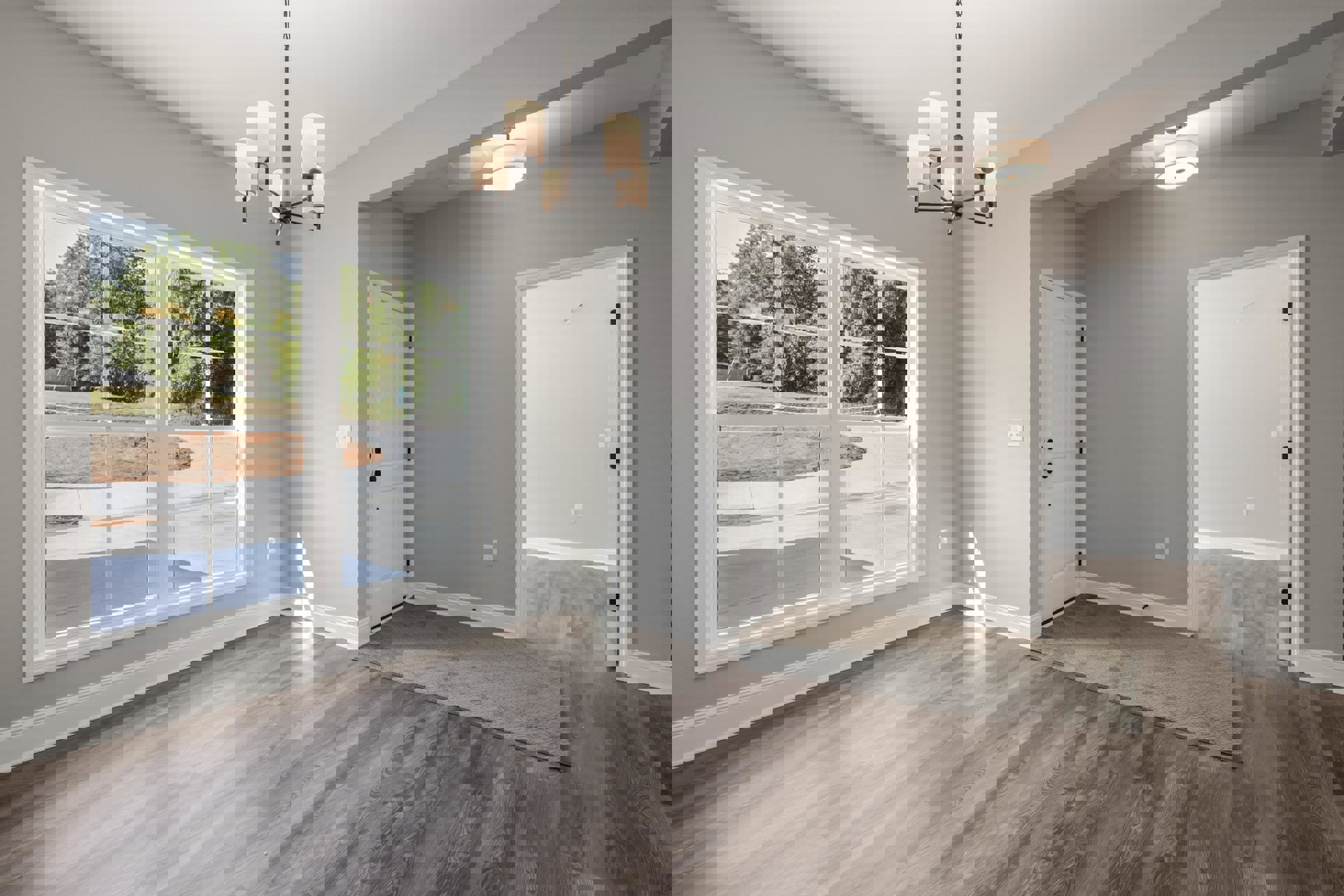 Wood flooring room featuring two white doors with black knobs, a window overlooking a green yard, and a ceiling-mounted light fixture with a white shade.