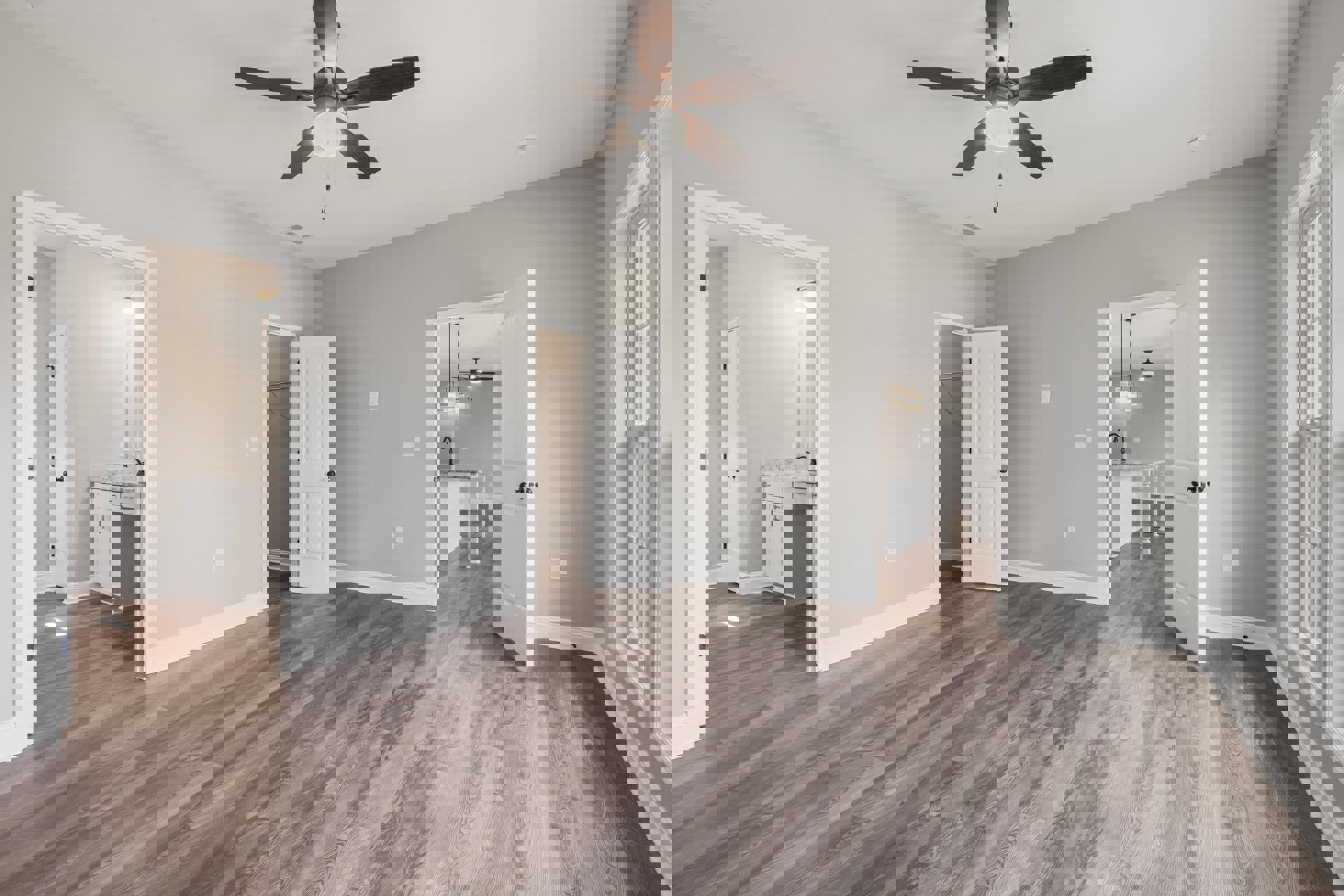 Ceiling fan with light fixture, wood flooring, white door with black knob, white kitchen counter topped with marble, neutral walls