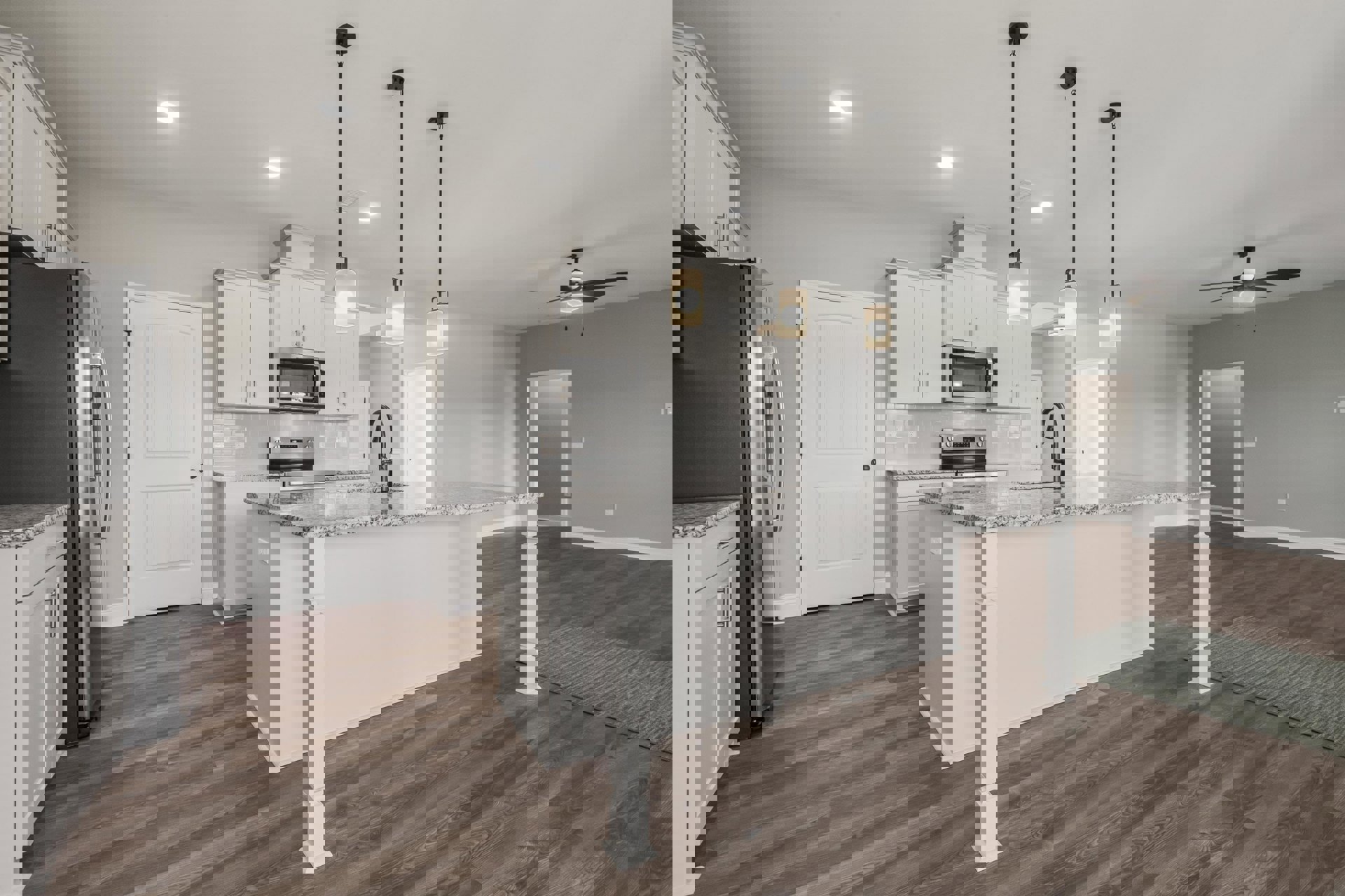 Kitchen with marble island countertop, wood flooring, white cabinetry, built-in microwave with glass door, wall-mounted light fixture, black door knob, and patterned rug.