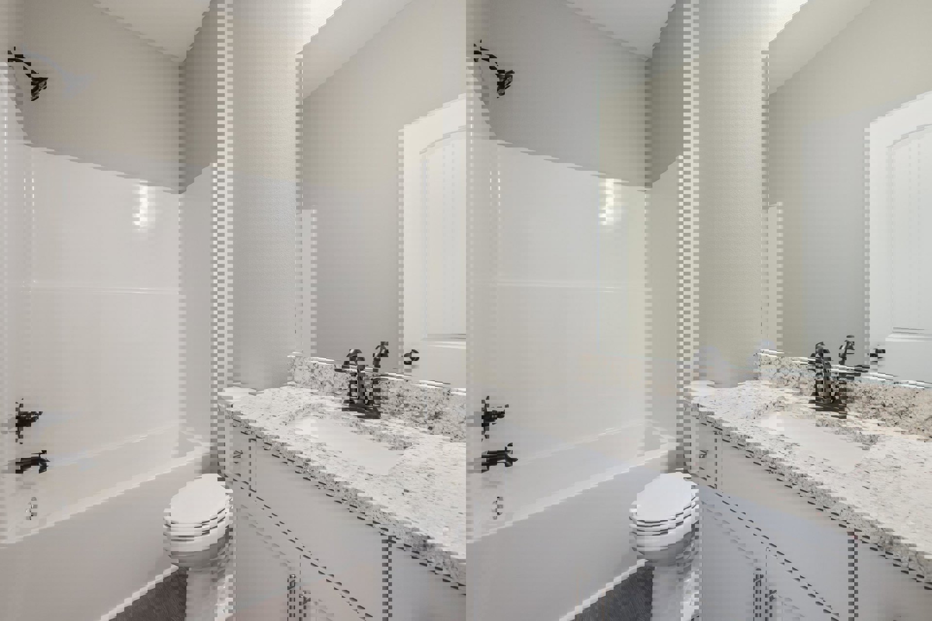 Modern bathroom featuring white tile walls, a rectangular sink with chrome faucet, wall-mounted mirror, white toilet with closed lid, and a built-in bathtub.