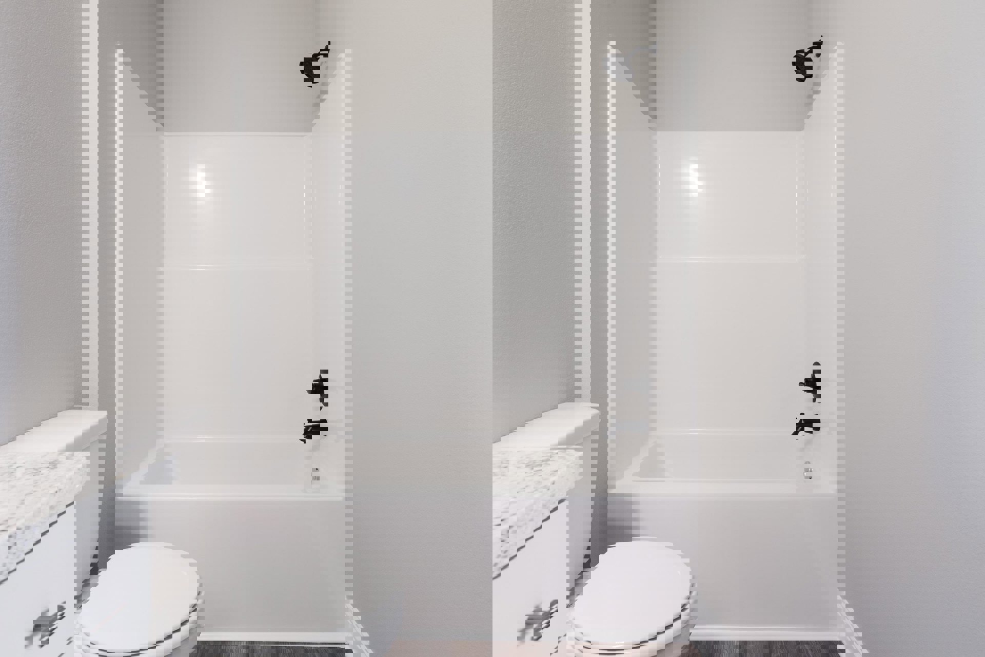 White bathtub and toilet with chrome fixtures, wall-mounted shower head with black pipe, white countertop with silver handle, light tile walls and floor.