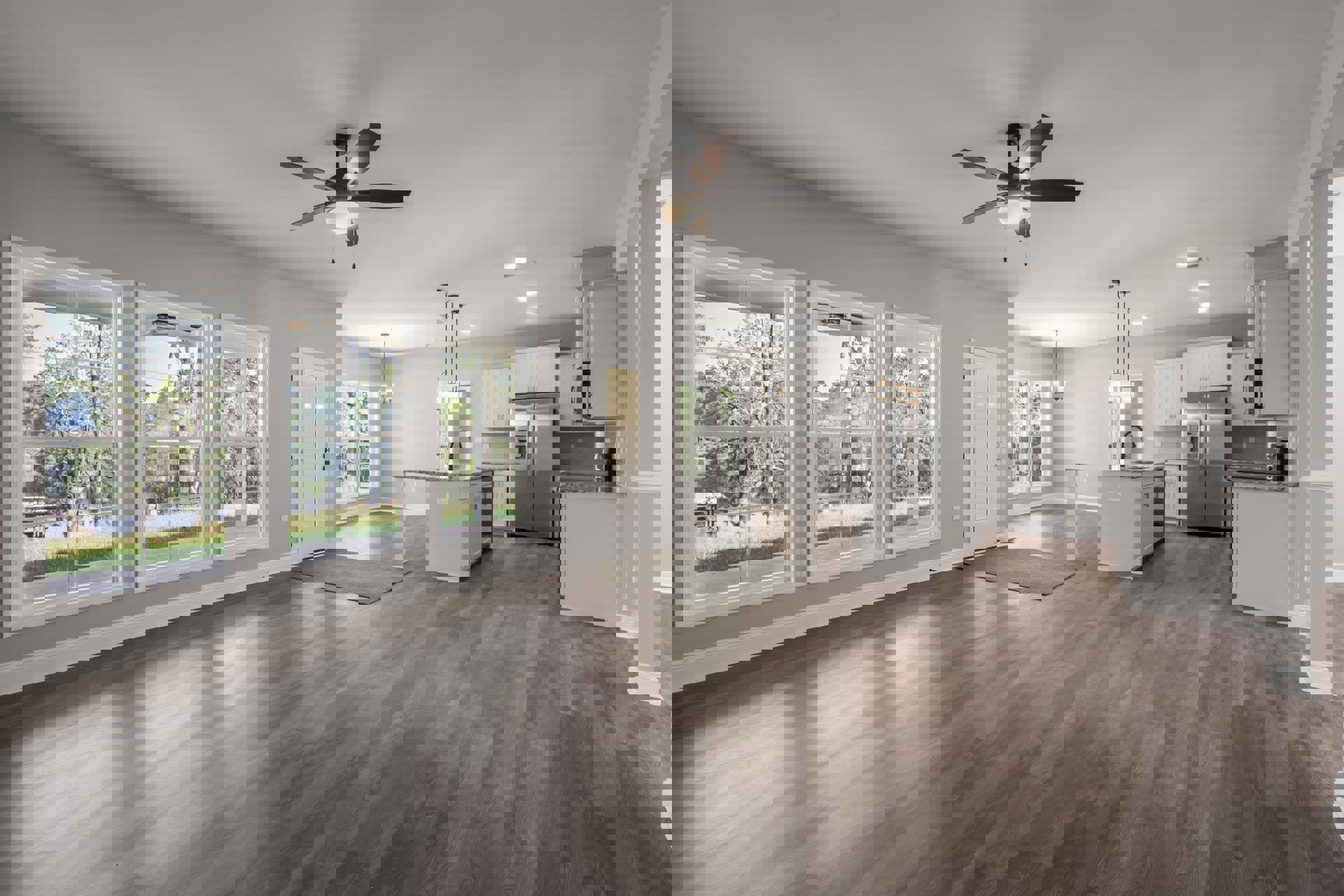 Open-concept kitchen and dining area with laminate wood flooring, stainless steel refrigerator, ceiling fan with light, white door featuring a mirror, large window overlooking lake