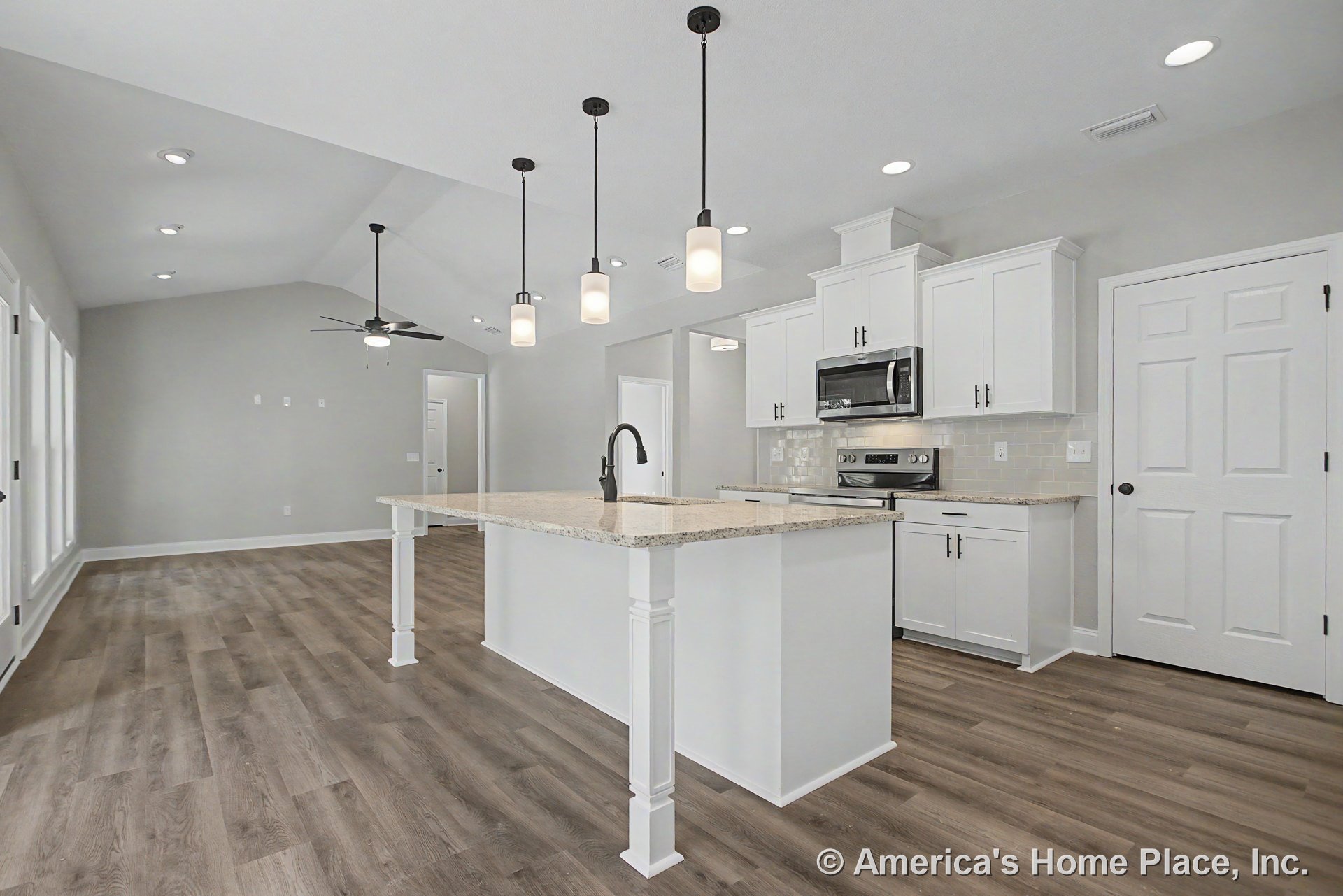 Open kitchen with white shaker cabinets, granite island countertop, stainless steel appliances, tile backsplash, wood-look flooring, vaulted ceiling, recessed lighting, and pendant