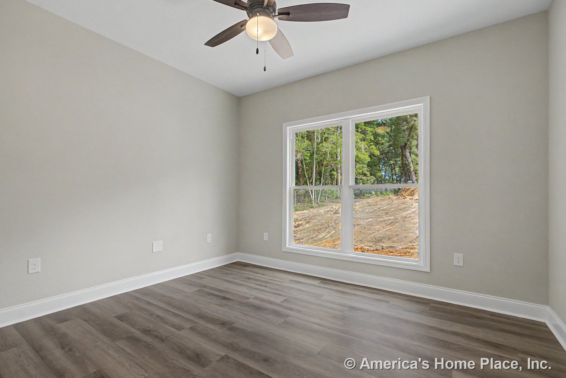 Bedroom with large double windows framed in white trim, light gray painted walls, wood-look vinyl plank flooring, white baseboards, ceiling fan with light, and multiple electrical