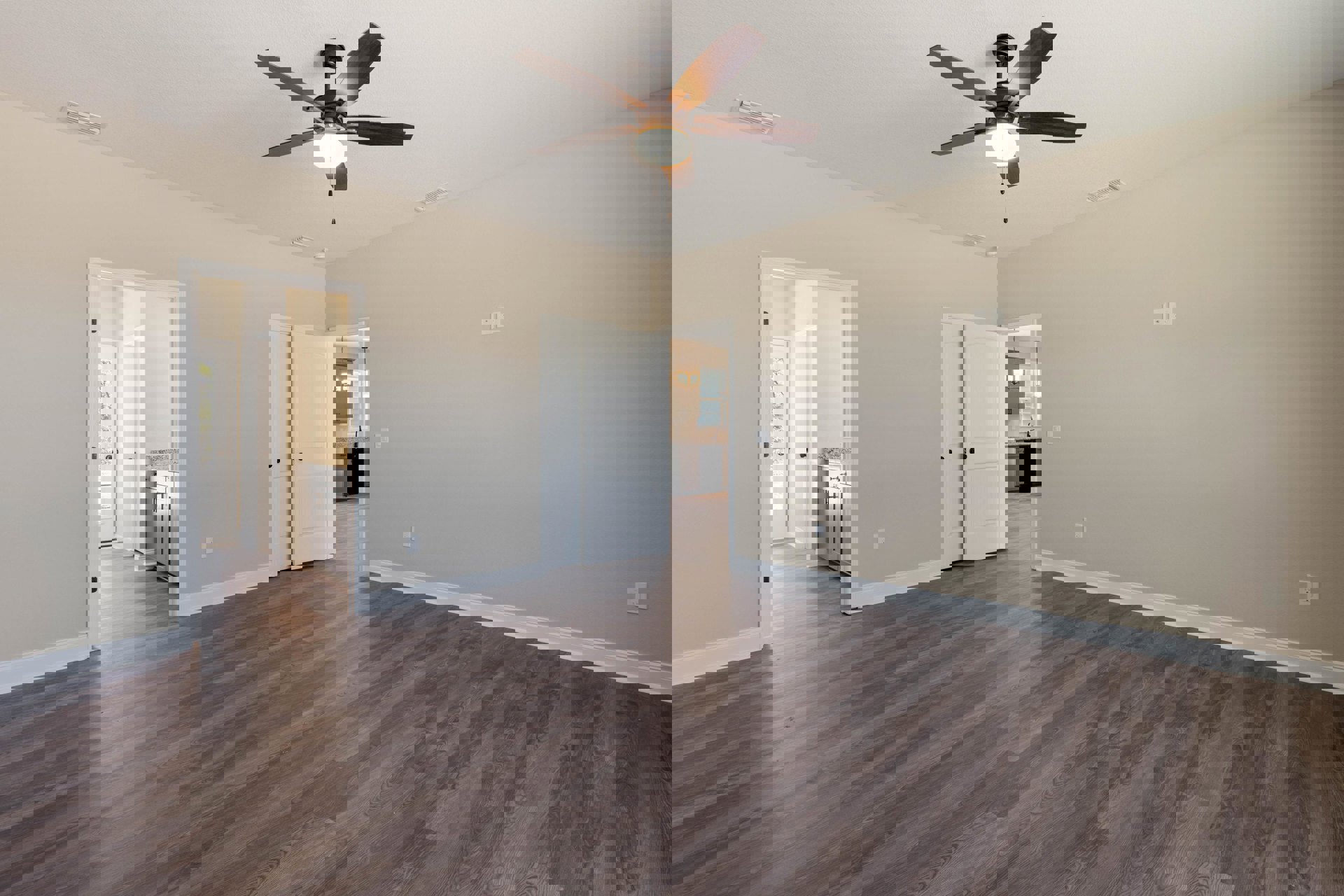 Ceiling fan with light fixture, hardwood floor with glossy finish, white door featuring black knob, white baseboards, neutral painted walls, partial view of built-in cabinet