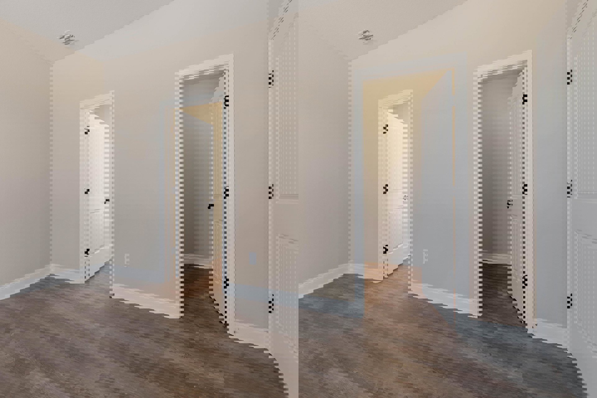 Wood floor with white baseboards, two open white doors with black hinges, white walls and ceiling