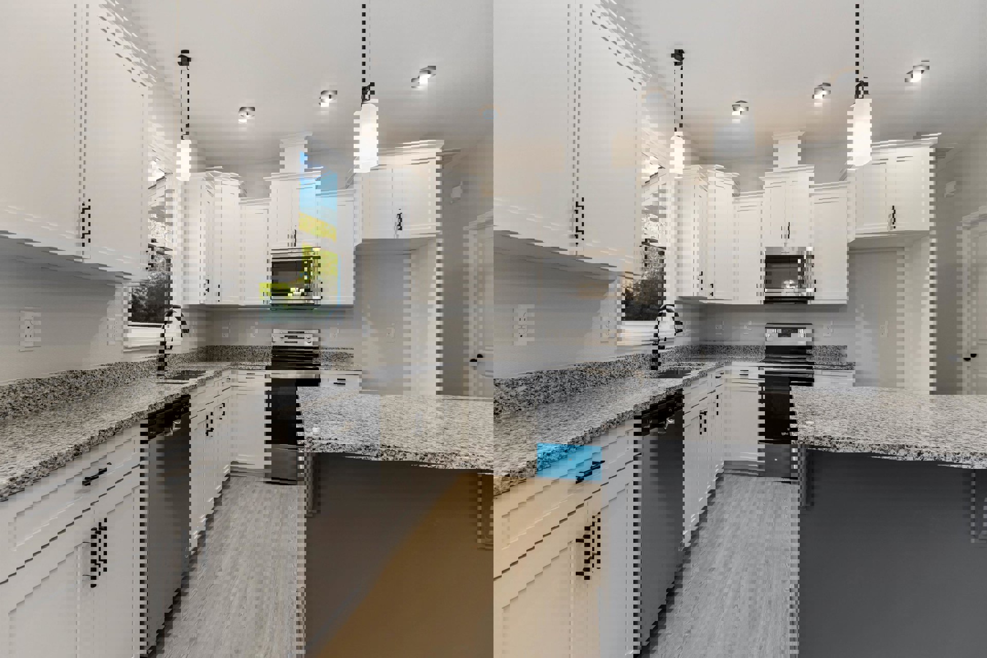 White kitchen with granite countertops, stainless steel microwave, grey backsplash, white cabinetry with black handles, electrical outlet, and white door