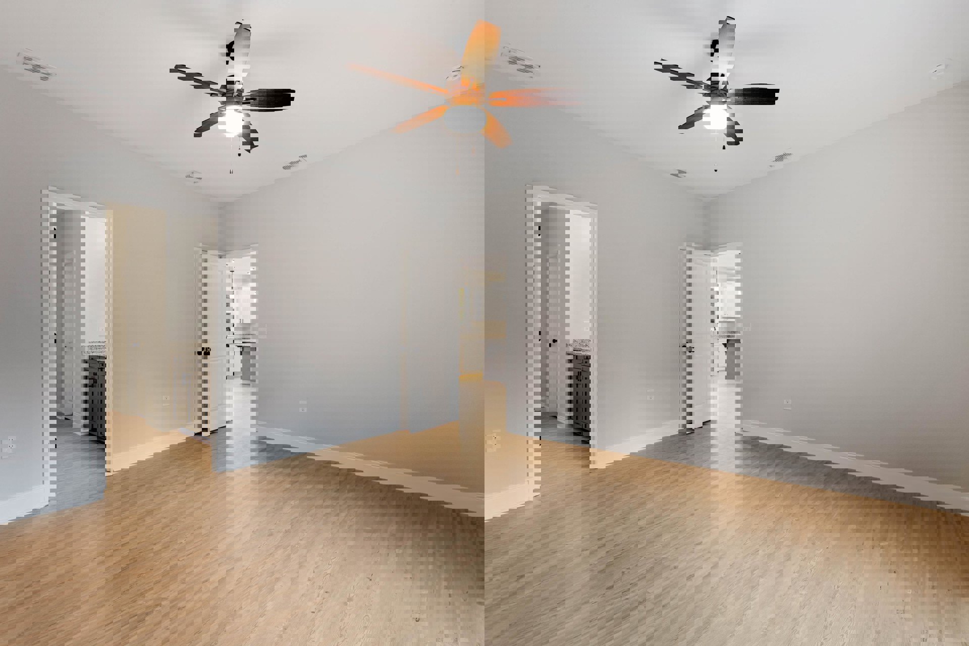 Ceiling fan with integrated light fixture, wood laminate flooring, white walls, open white door with black hardware, partial view of built-in cabinet