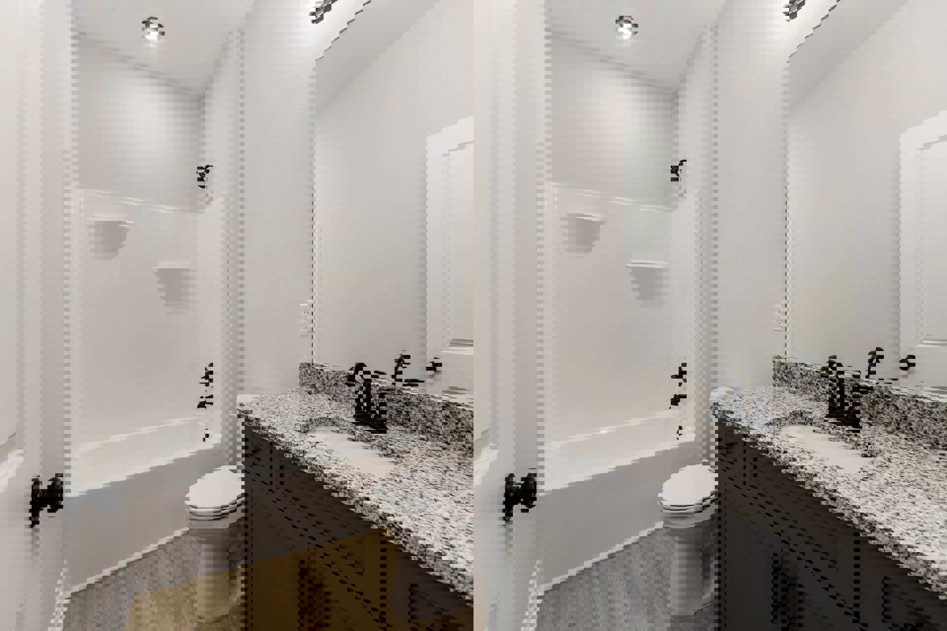 Bathroom with white tile walls, a white toilet with seat down, rectangular sink and chrome faucet, built-in bathtub, overhead ceiling light, and wall-mounted shower head.