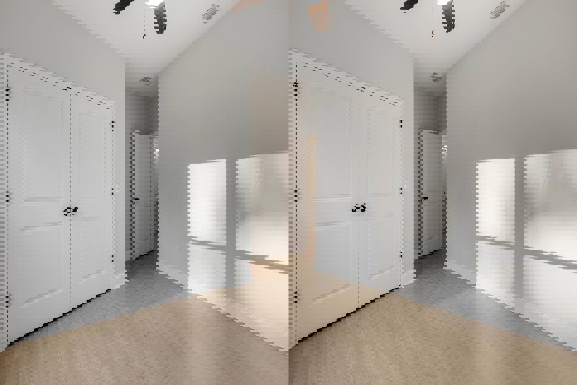 Wood floor with white walls, white double doors with black knobs, single white door with black knob, ceiling fan, white square object on gray background