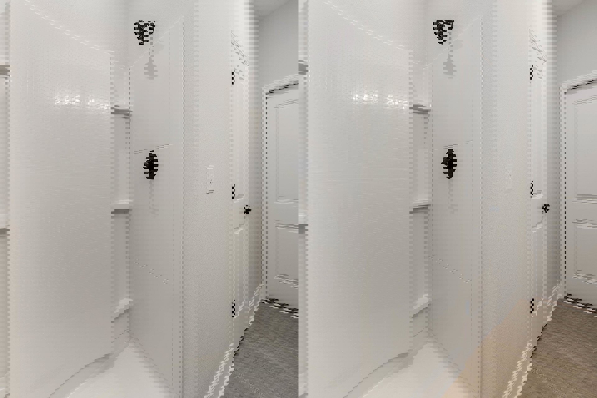 White tile shower with matte black showerhead and handle, black hardware on glass door, white plaster walls, light tile flooring