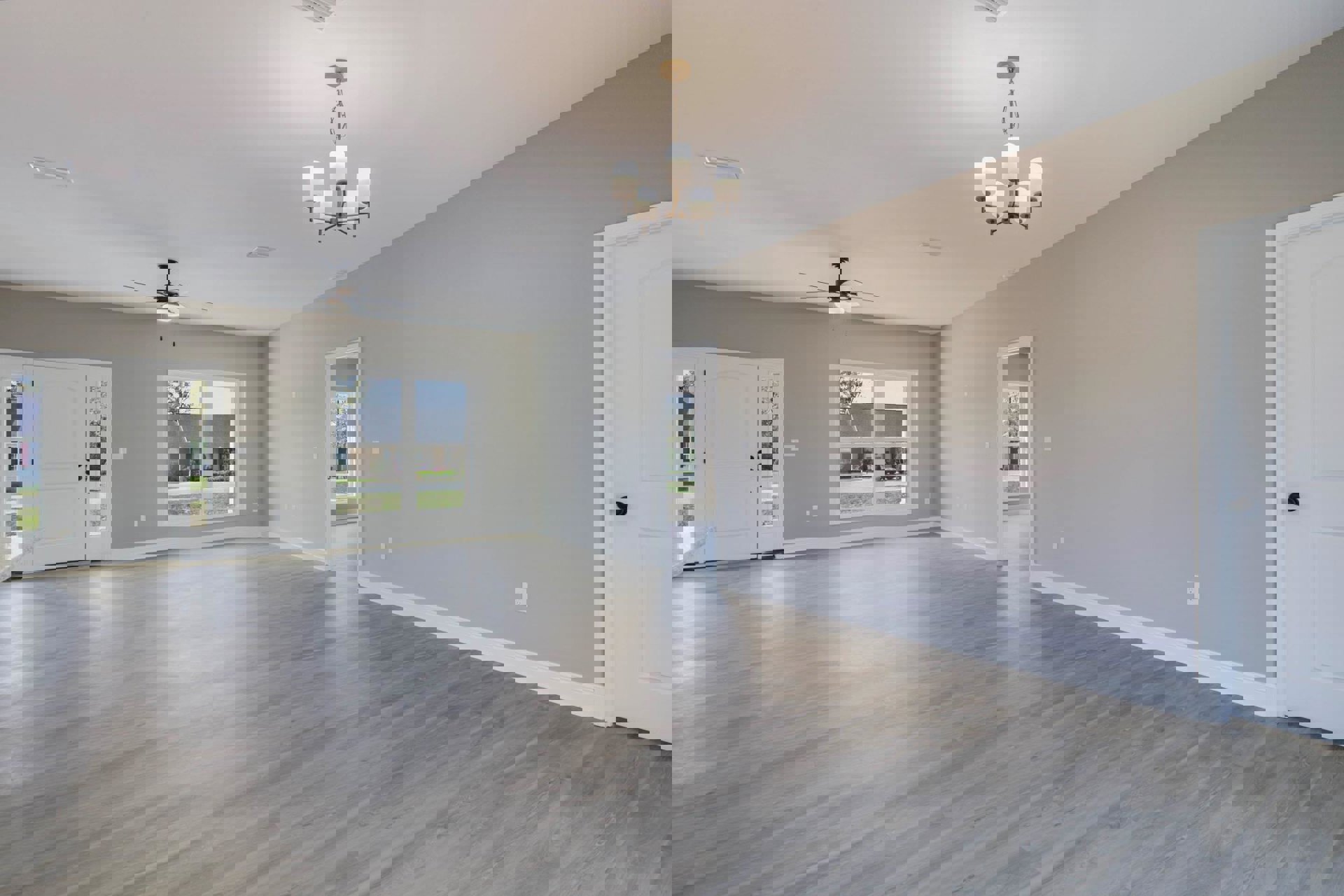 Wood flooring and white walls, ceiling fan overhead, double glass doors with white trim, window offering view of neighboring house, close-up of silver door knob, chandelier with