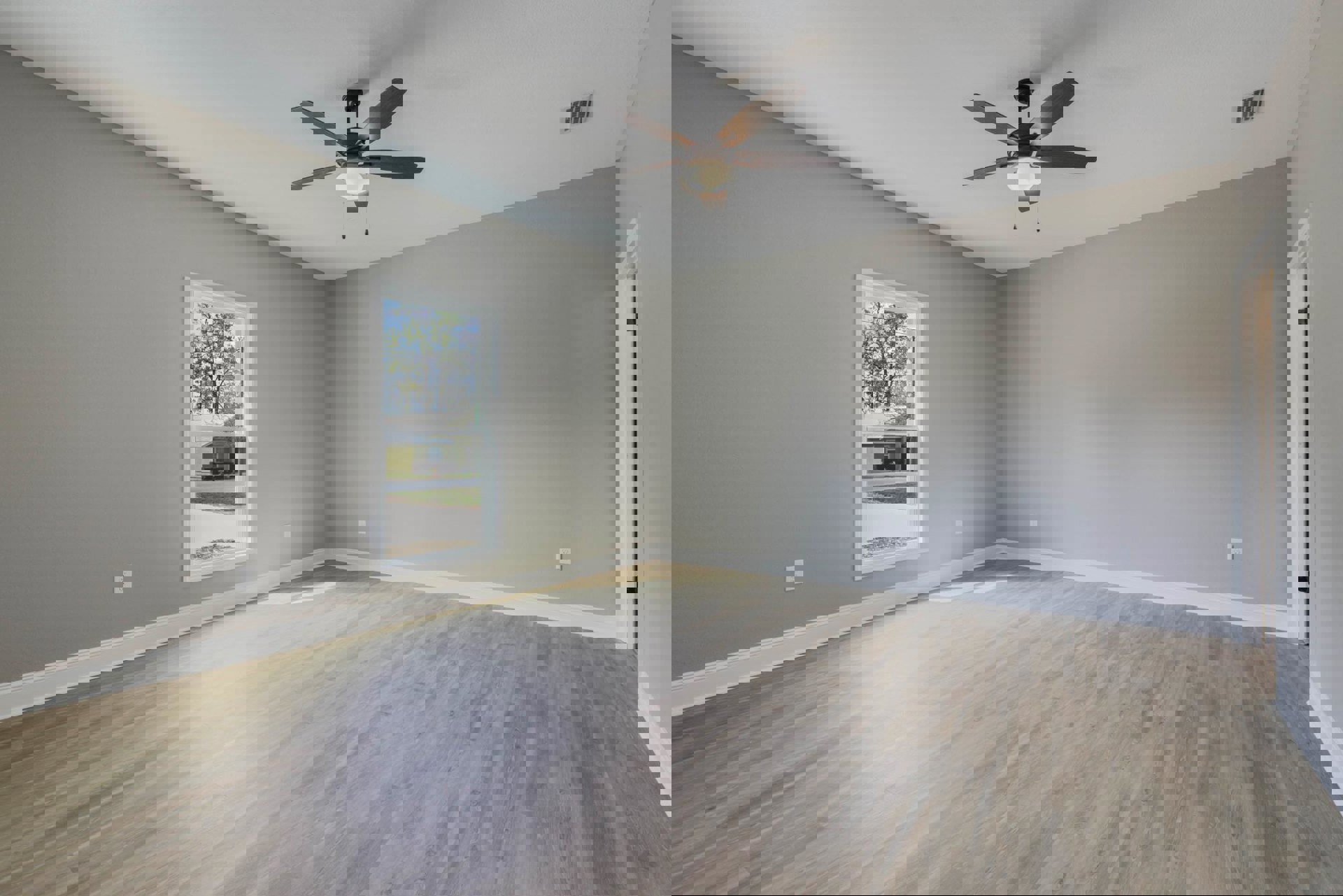 Light wood flooring in a room with white plaster walls, ceiling fan with integrated light, rectangular window, and wall vent