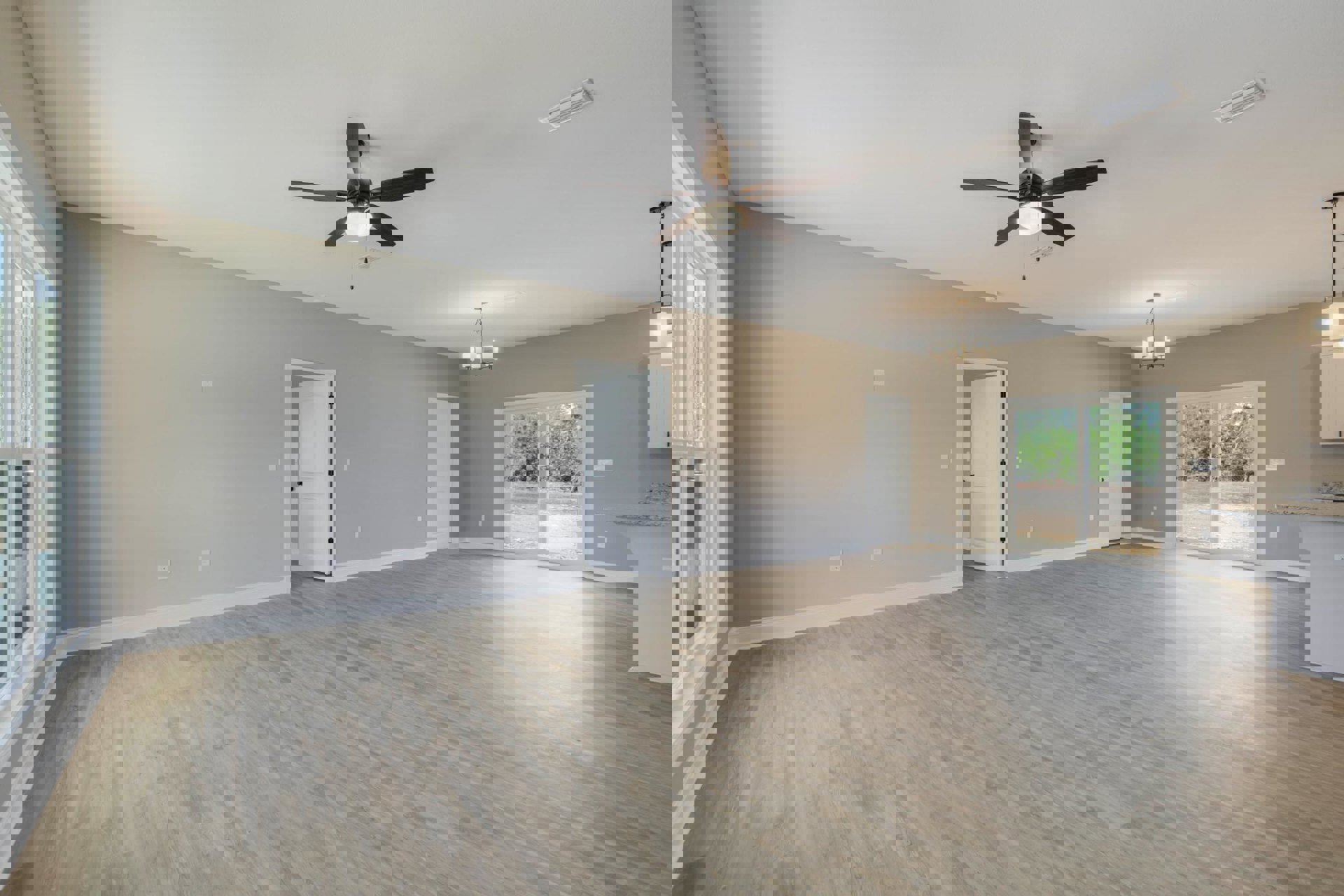 Ceiling fan with light fixture, wood flooring, white walls, white door with black handle, window showing outdoor view