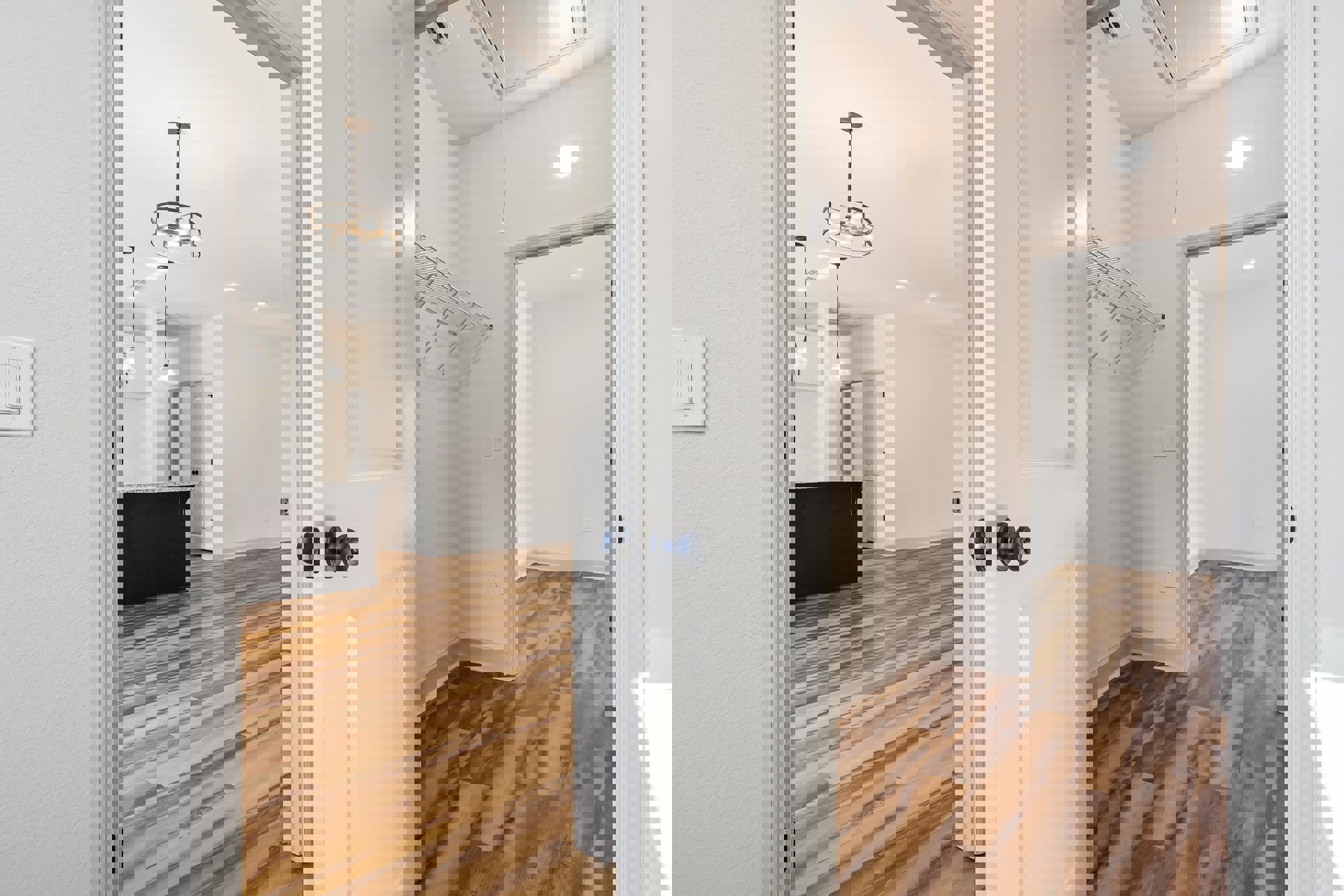 White paneled door with black knobs, hardwood flooring, ceiling light fixture, metal wall shelf, light switch, and countertop in a neutral-toned room.