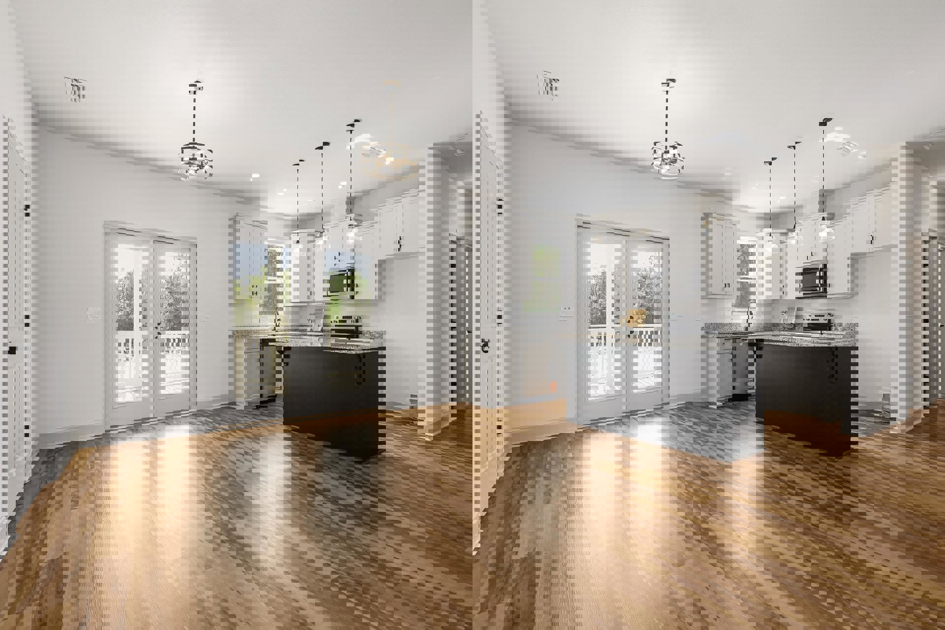 Kitchen with wood flooring, black marble countertop, white cabinetry, glass-paneled double doors, stainless steel microwave, and modern light fixture.