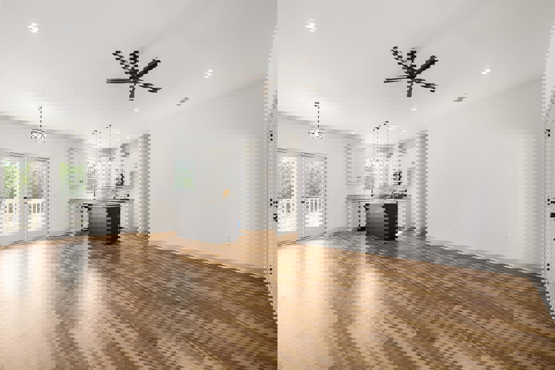 Open concept kitchen with granite island, wood flooring, white walls, ceiling fan with light, and double glass-paneled doors