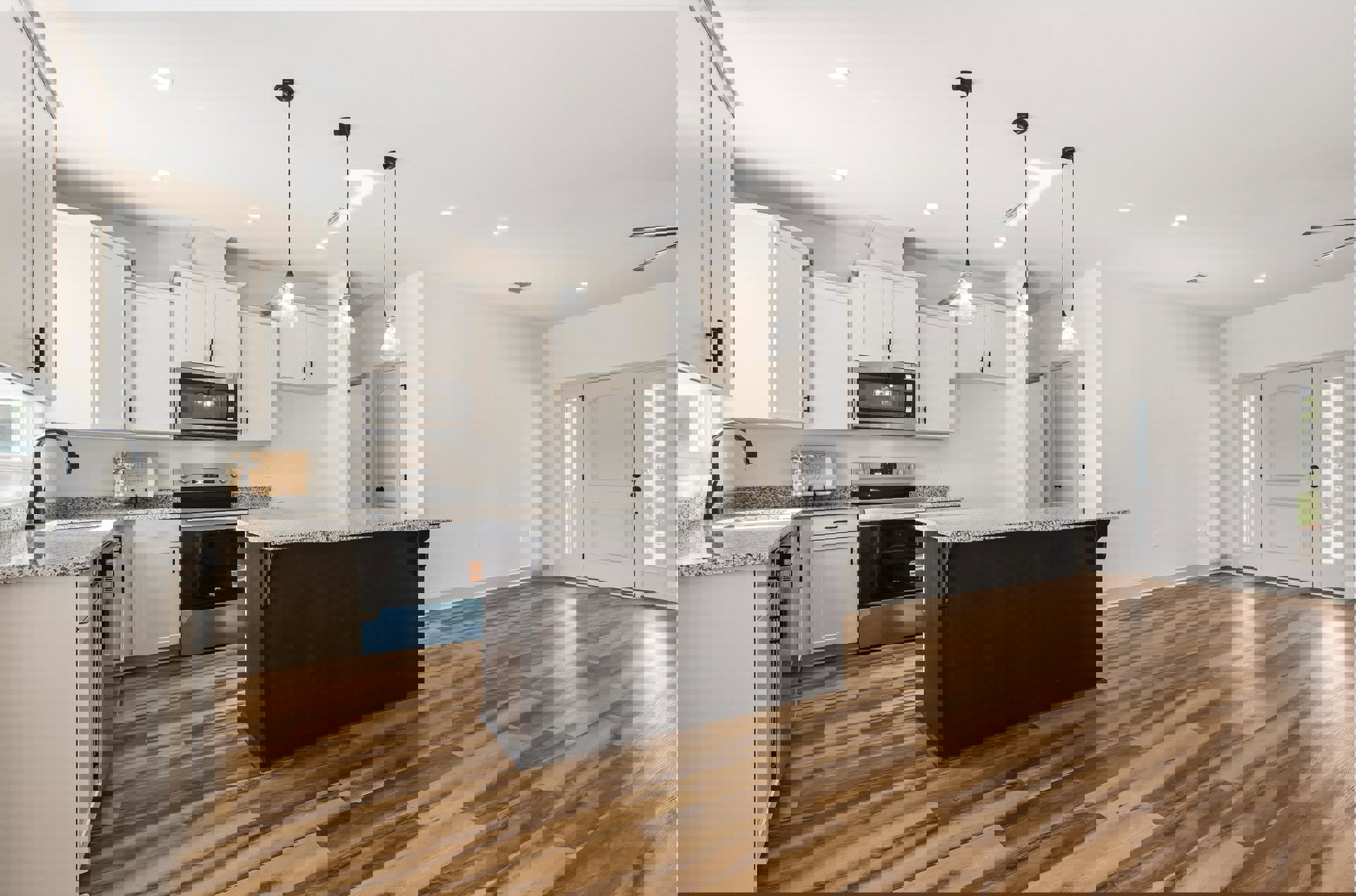 Kitchen with wood flooring, central island featuring light stone countertop, white cabinetry, stainless steel microwave, glass-paneled door, and black accent door.