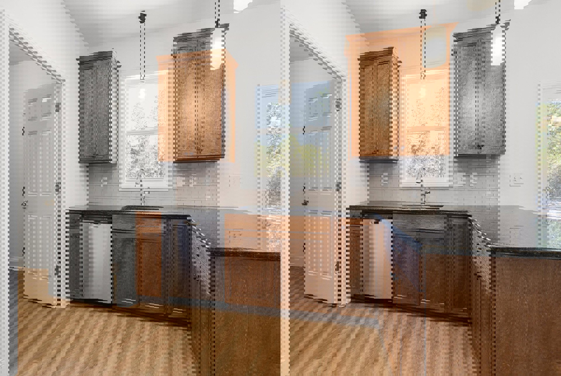 Kitchen featuring dark wood cabinets, stainless steel dishwasher, white refrigerator with silver handle, wooden cabinet with matching countertop, white door with doorknob, overhead