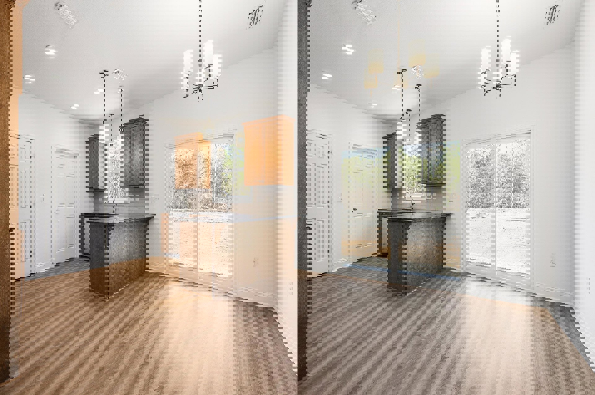 Kitchen with hardwood flooring, wooden cabinets, kitchen island with faucet, sliding glass door overlooking trees, white door with black handle, modern light fixture.