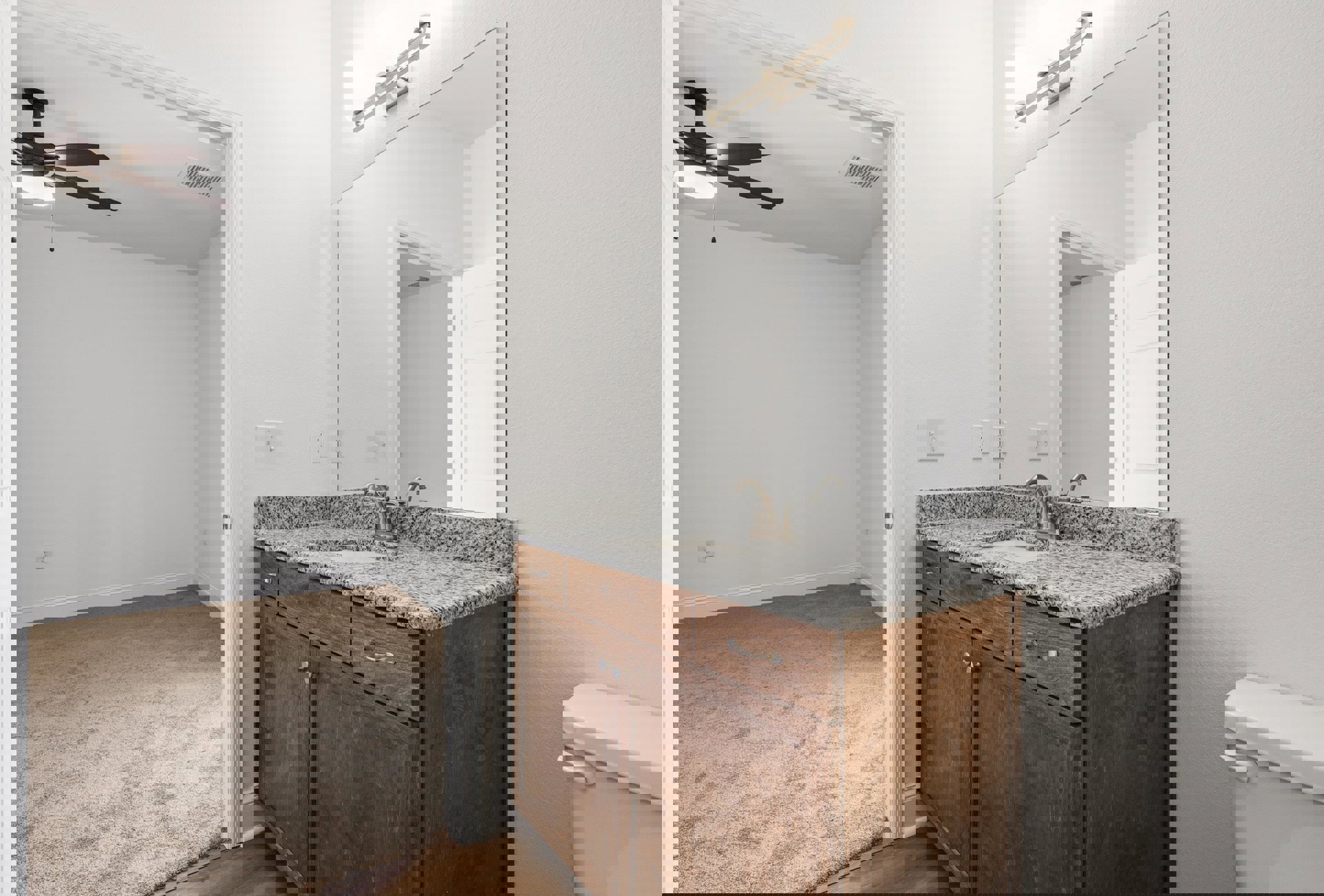 White bathroom with rectangular mirror above a quartz countertop sink, dark wood cabinetry, chrome faucet, and tiled walls